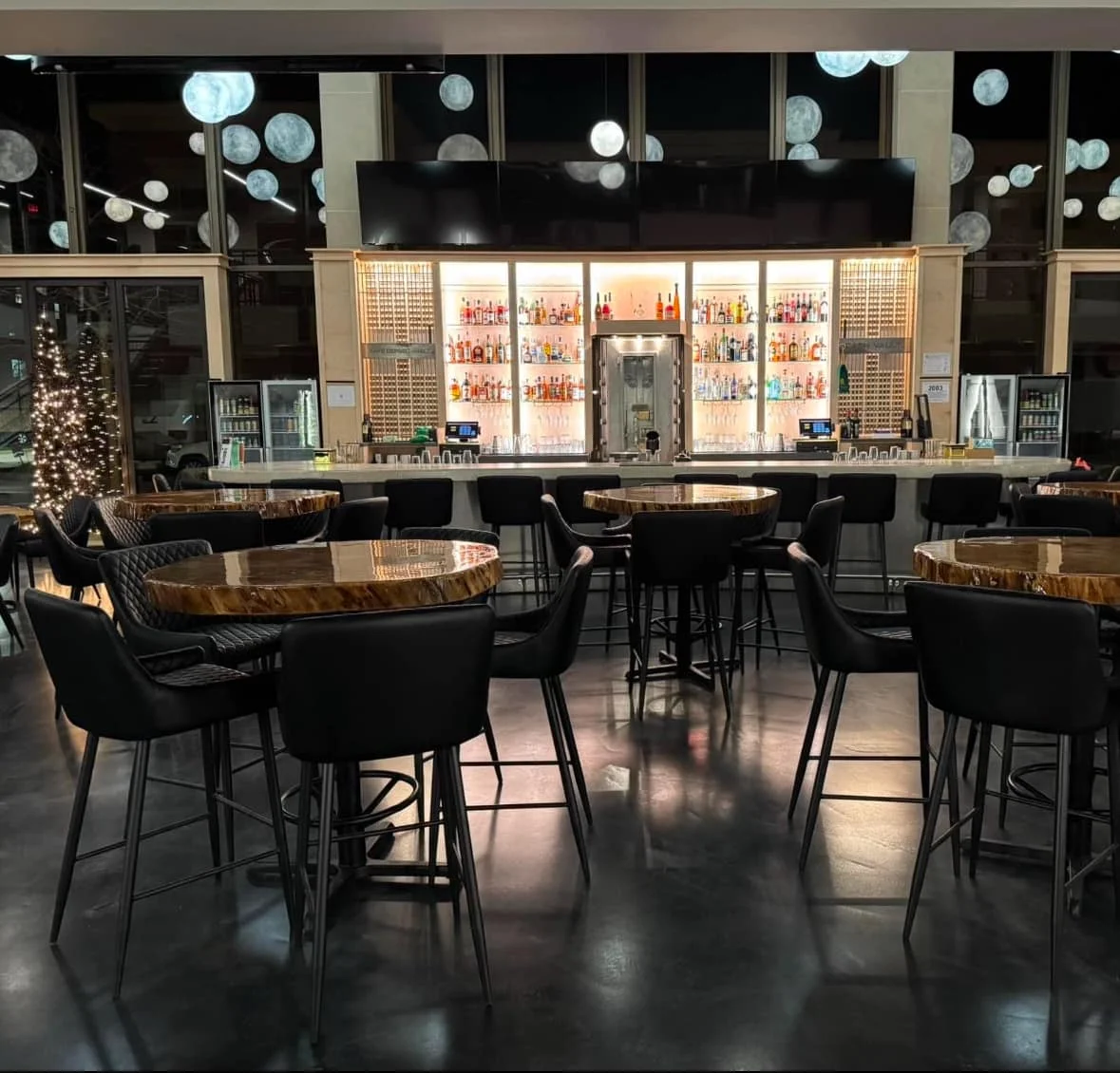 Modern bar interior with stylish seating and illuminated shelves