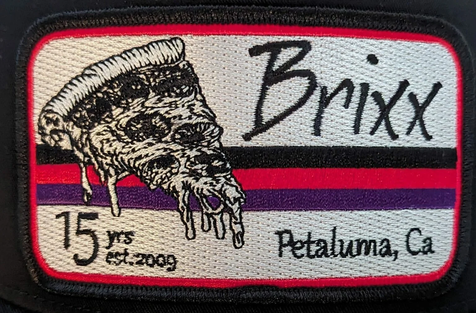 Embroidered patch featuring a slice of pizza from Brixx in Petaluma, CA