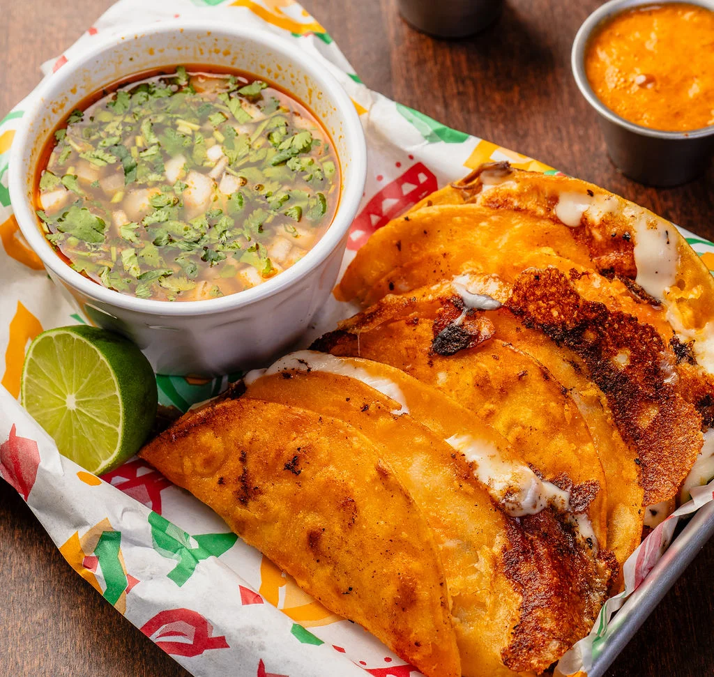Crispy tacos with consommé and lime, a traditional Mexican dish