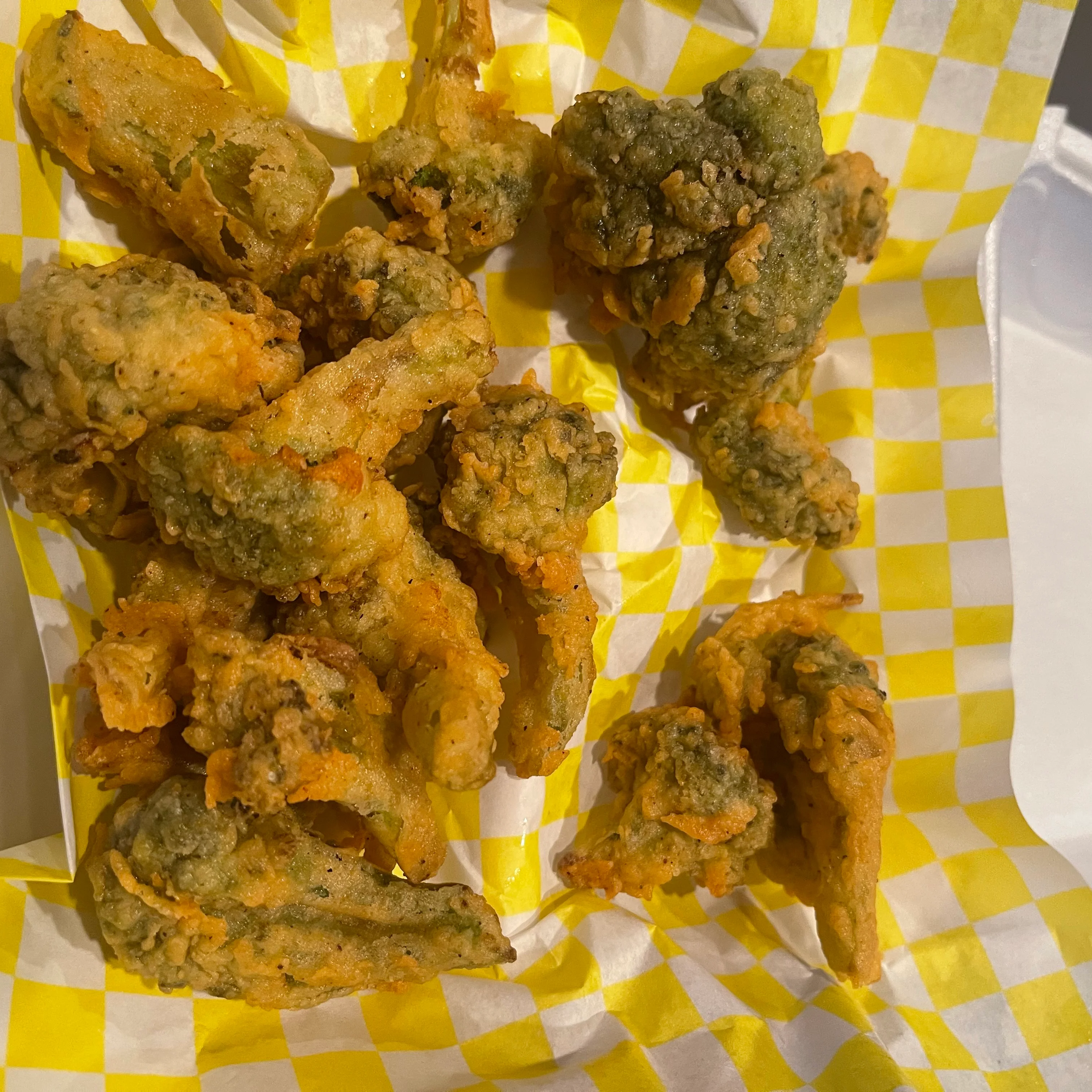 Southern-style fried okra served in a takeout container