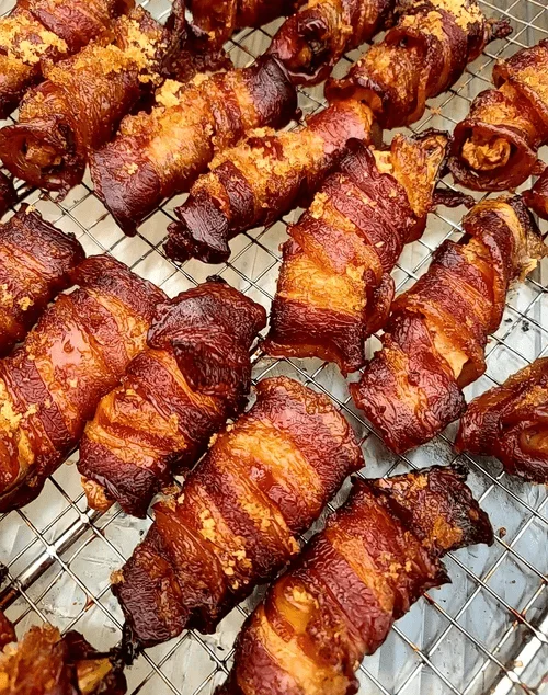 Crispy bacon-wrapped jalapeño poppers on a cooling rack
