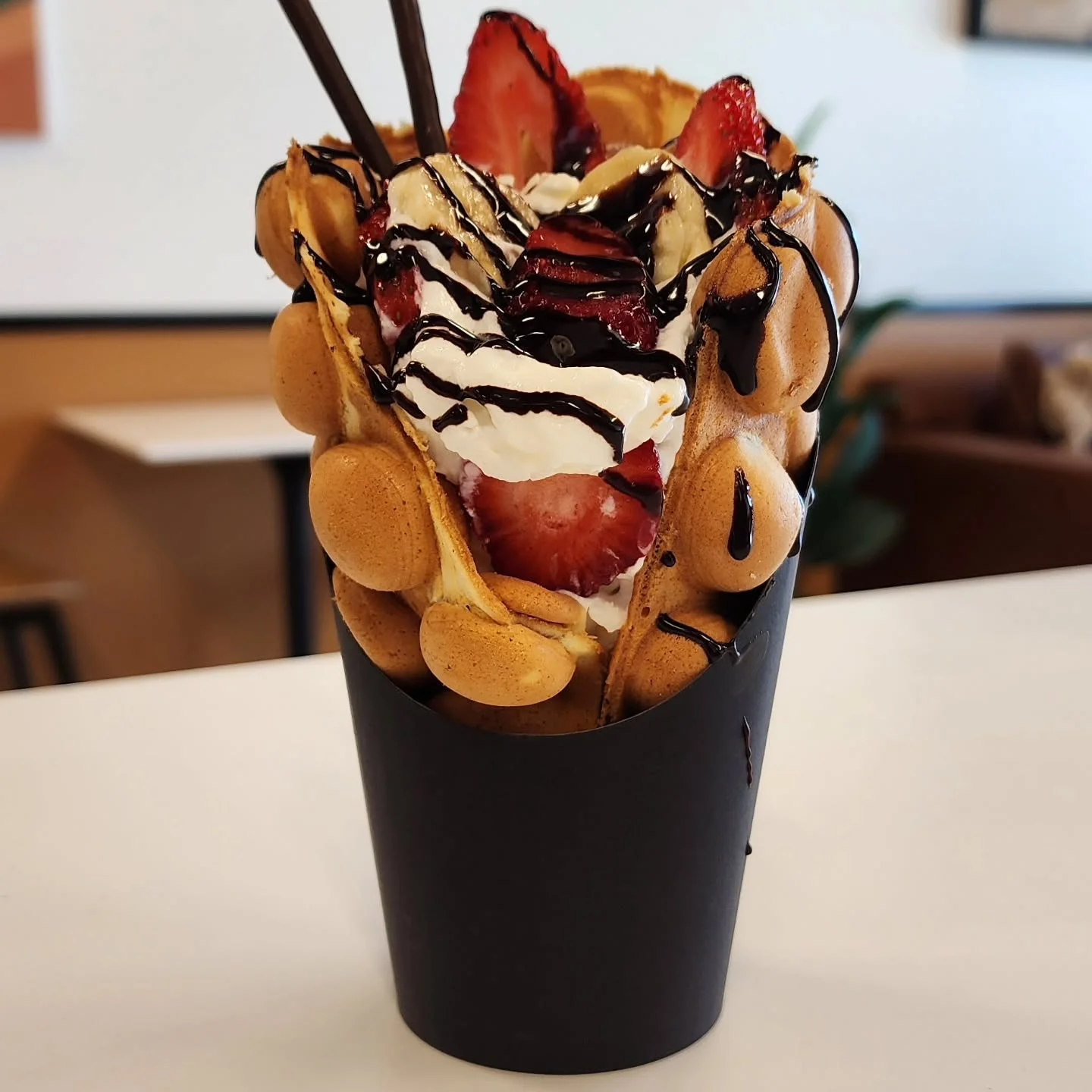Hong Kong-style egg waffle dessert with strawberries and whipped cream