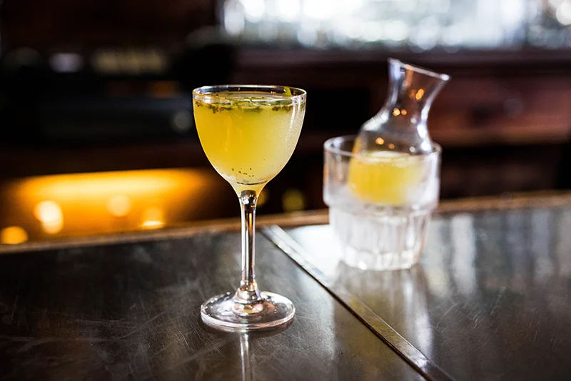 Craft cocktail served in a stylish glass at a modern bar