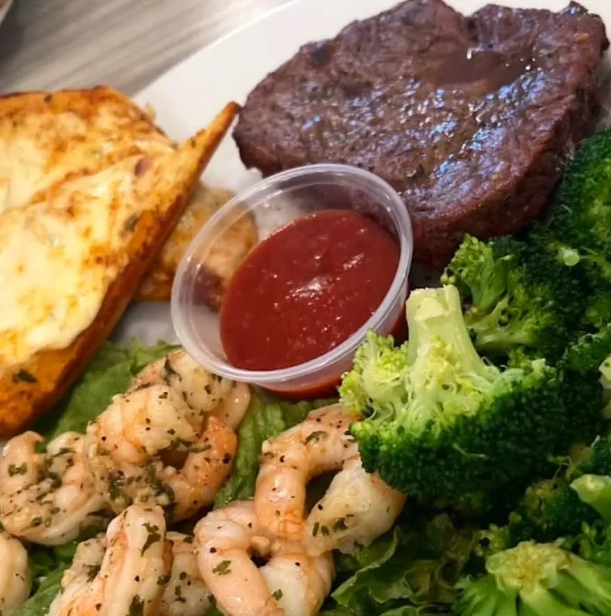 Grilled steak with shrimp and broccoli on a plate