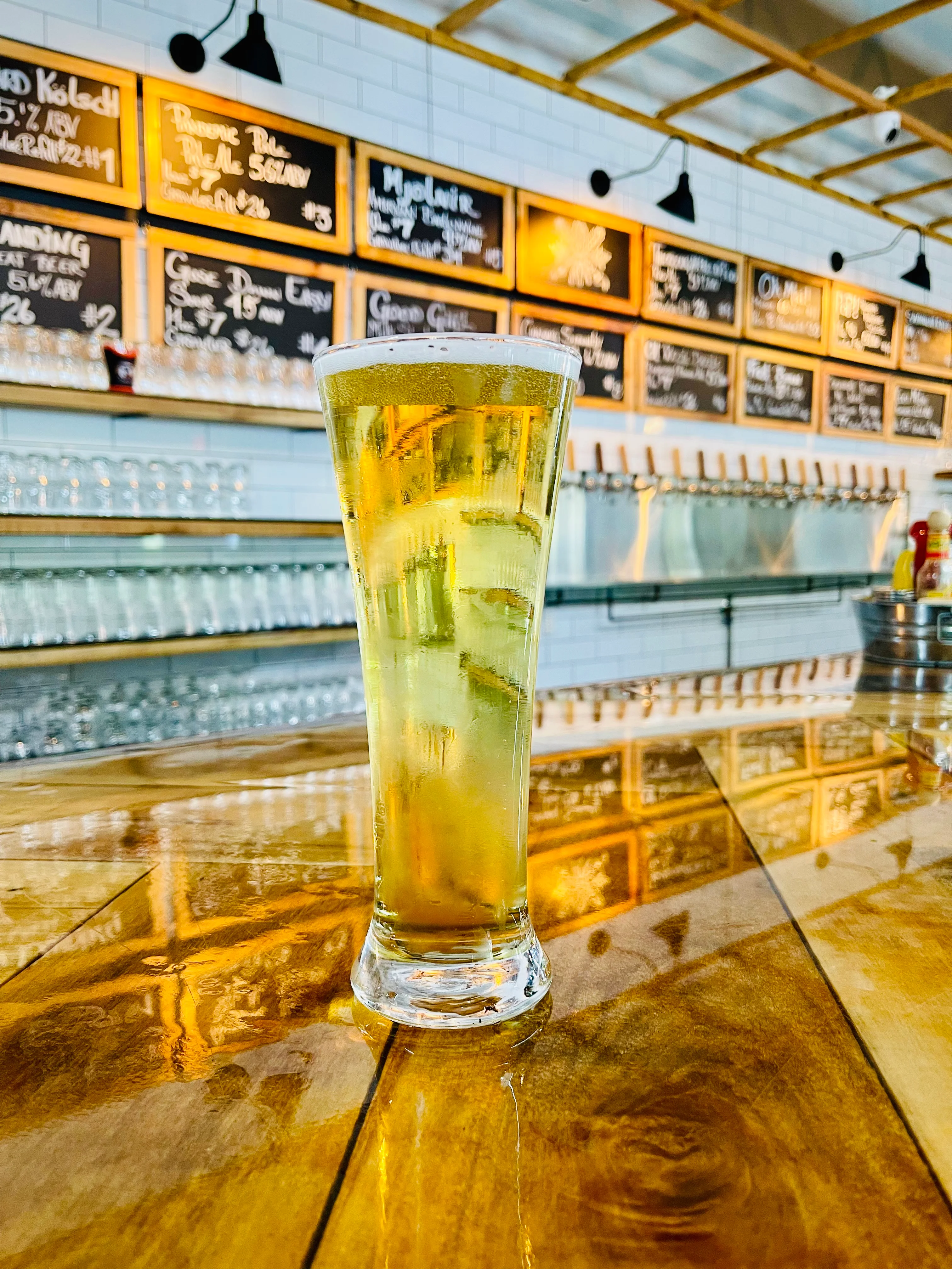 Refreshing craft beer in a tall glass at a modern bar