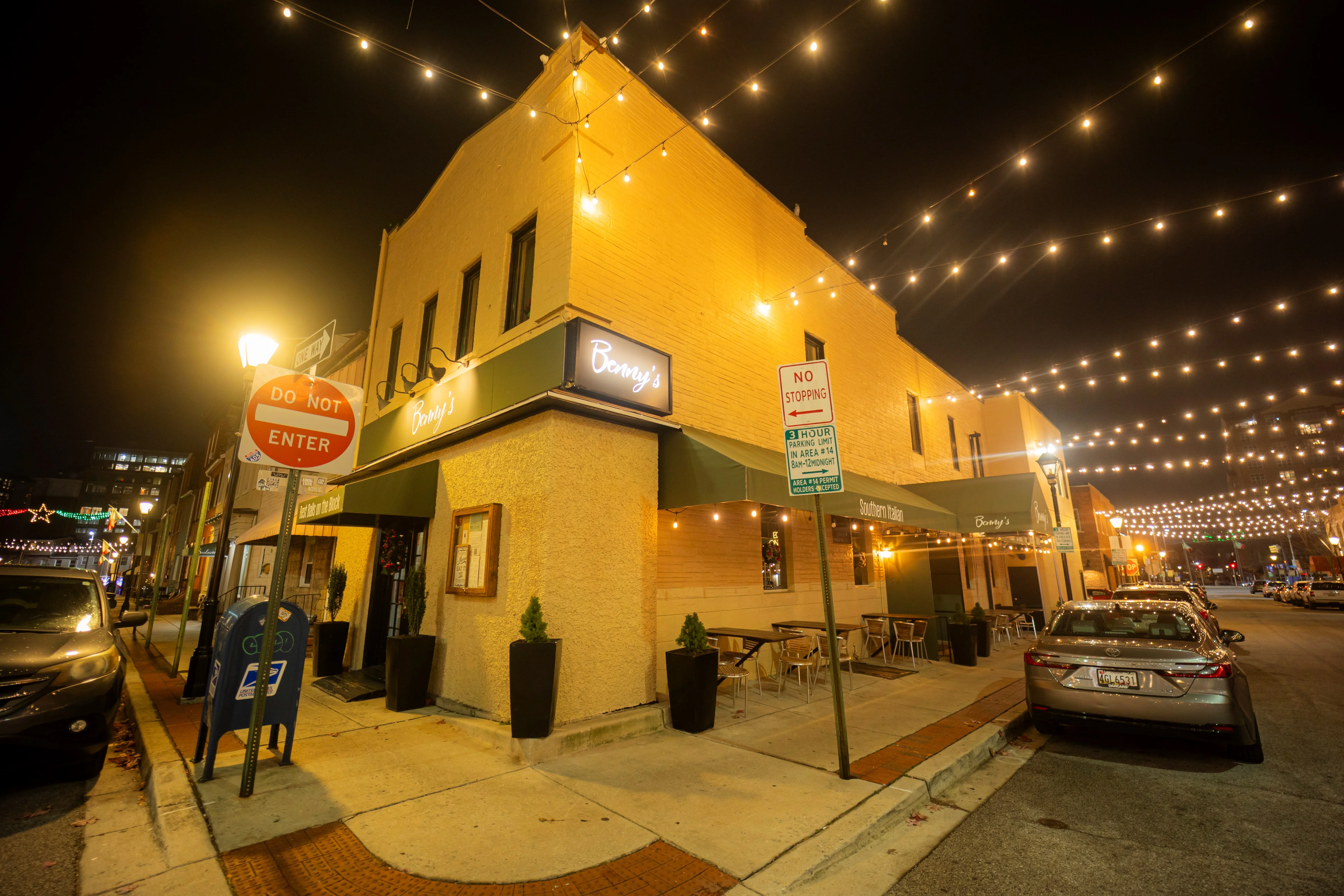 Charming restaurant exterior with string lights at night