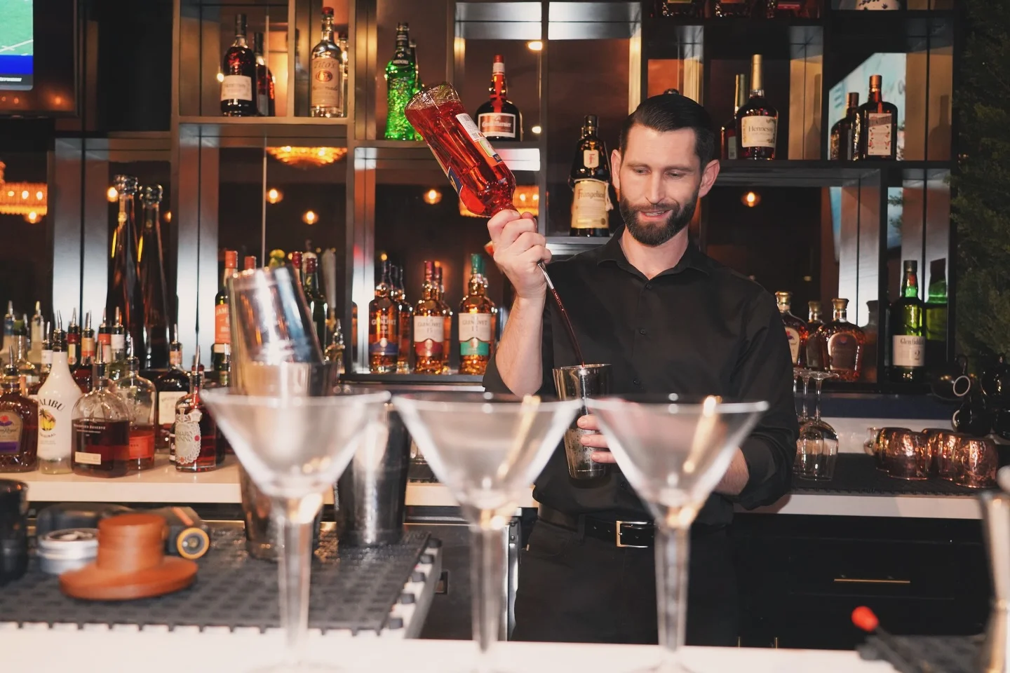 Bartender mixing a cocktail at a stylish bar