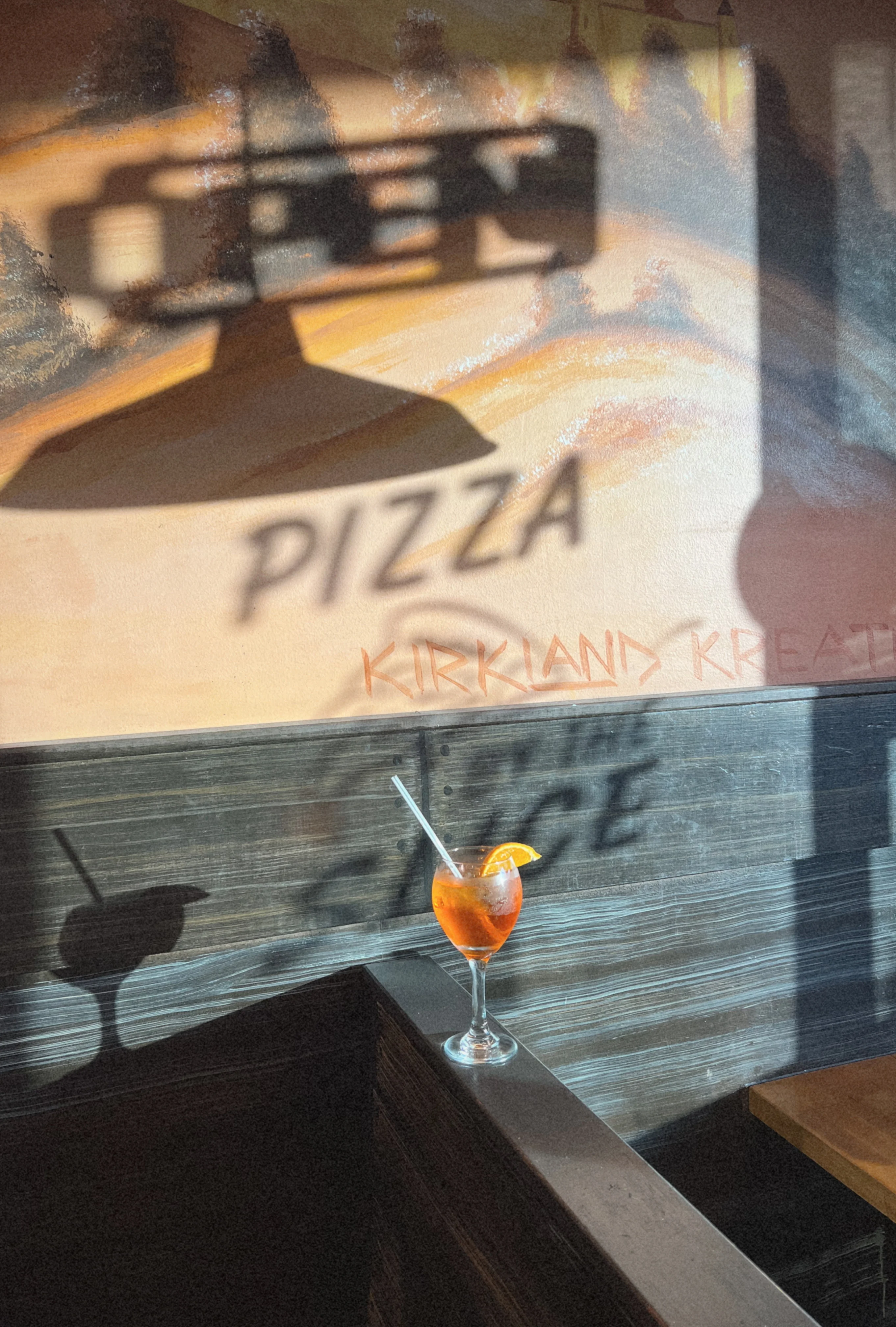 Cocktail on a bar counter with pizza-themed decor