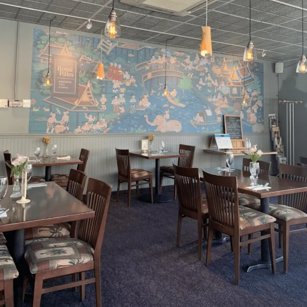 Cozy restaurant interior with artistic mural and warm lighting