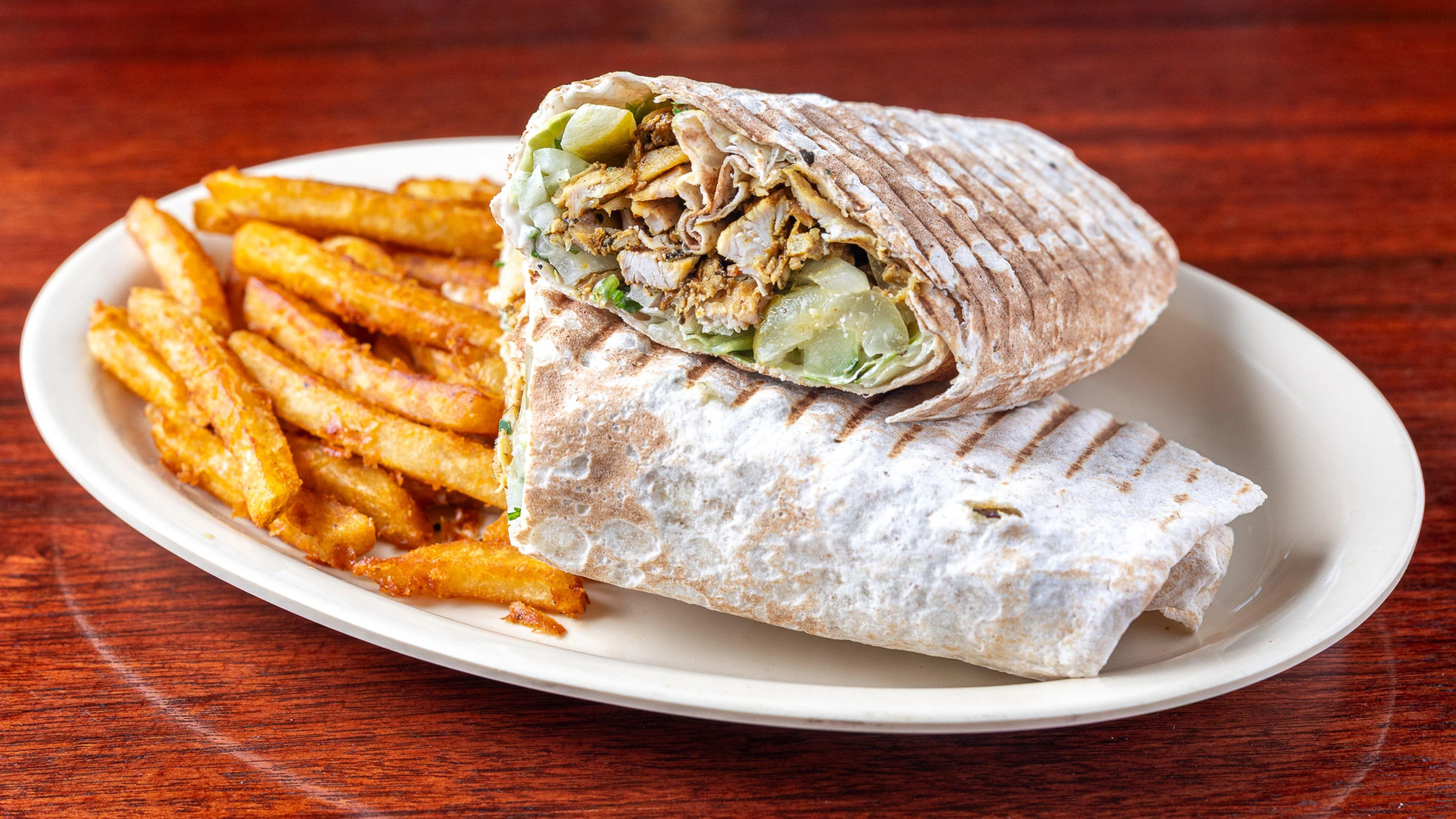Pita Zone shawarma lavash wrap served with seasoned fries