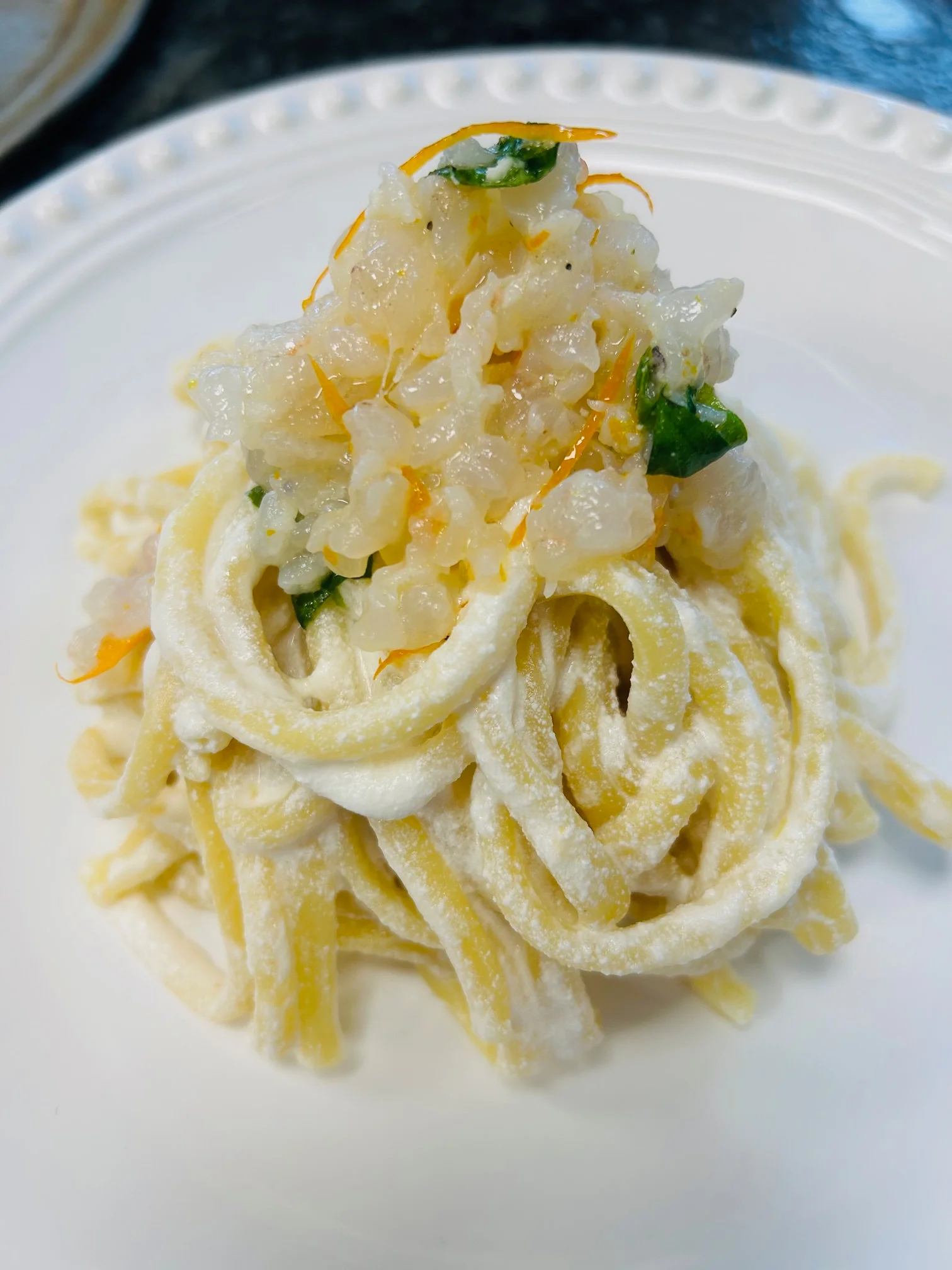 Italian linguine with seafood and citrus garnish