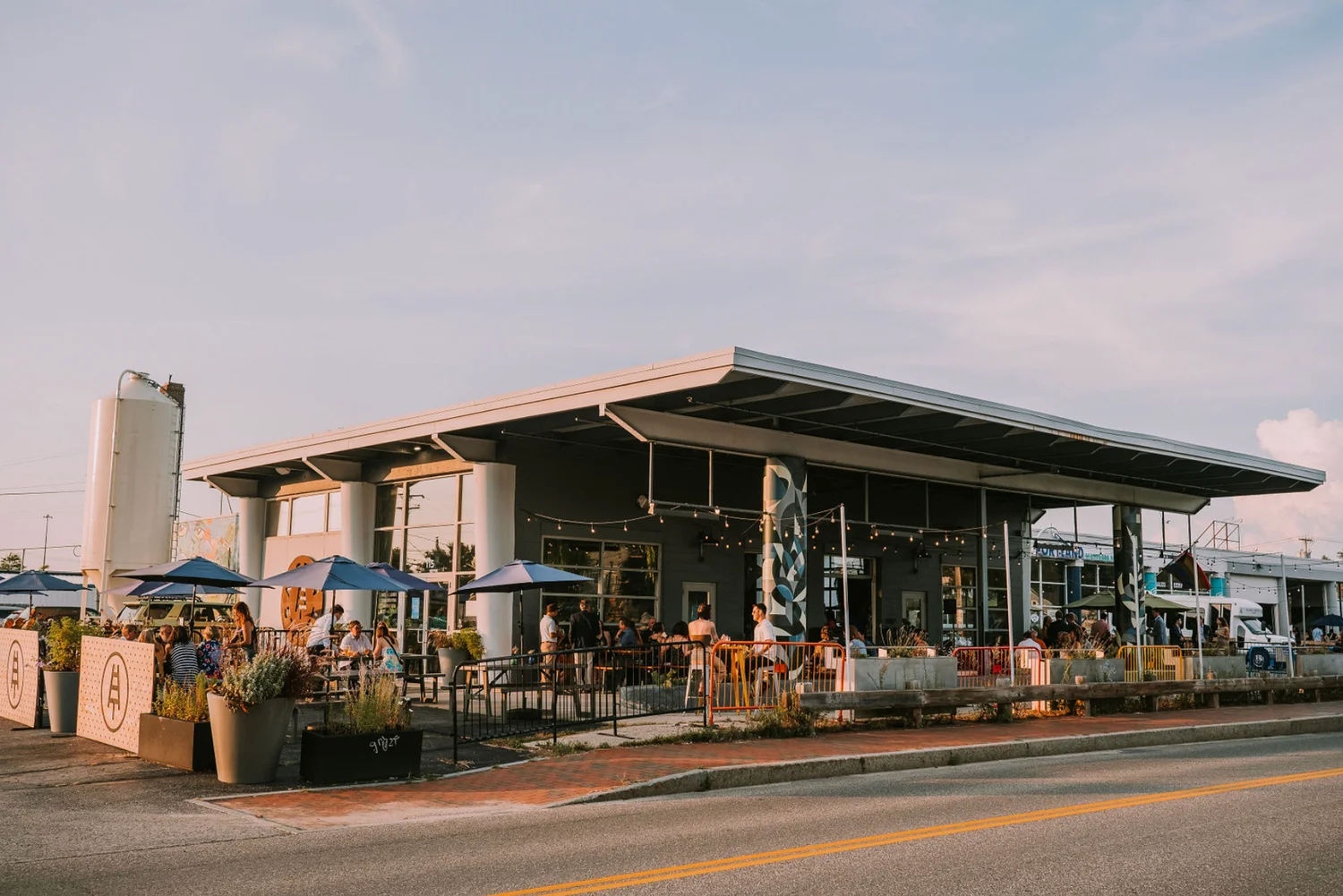 Modern restaurant exterior with outdoor seating and vibrant atmosphere