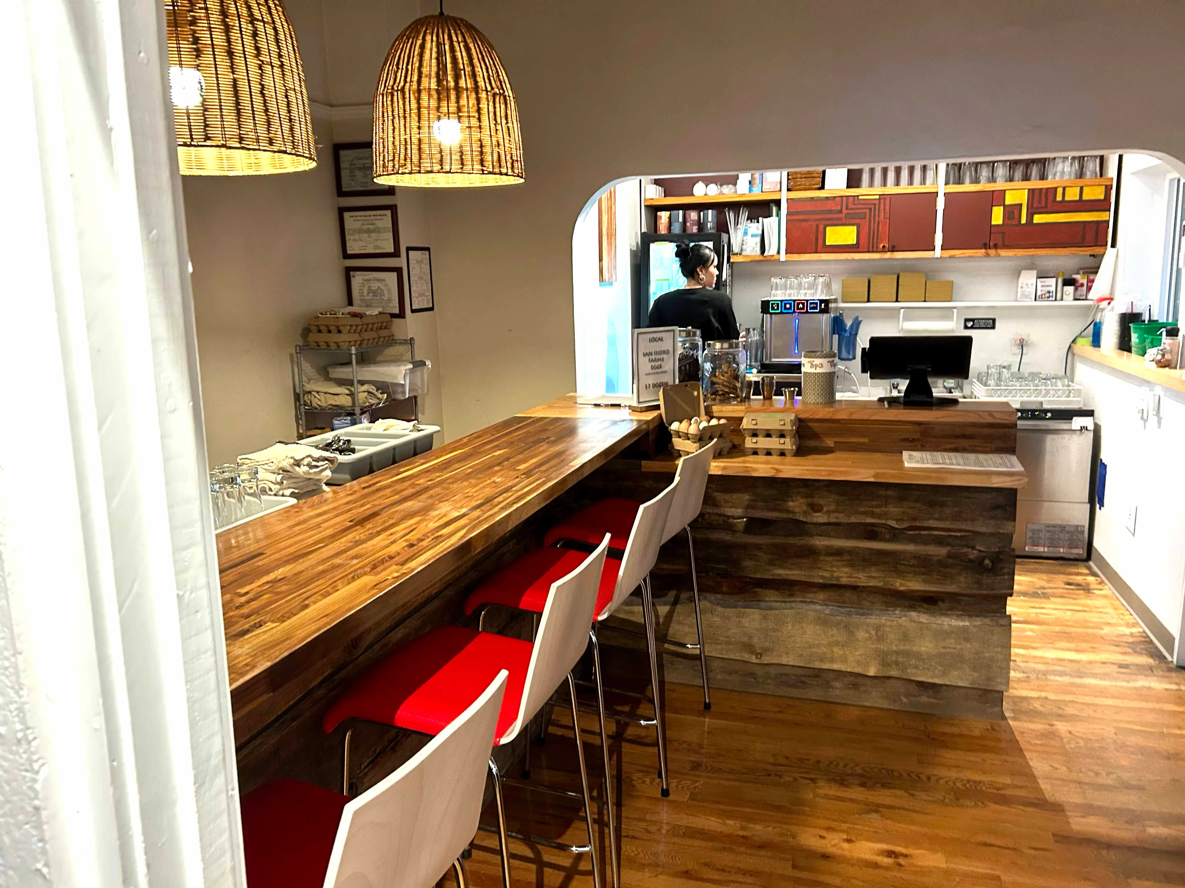 Cozy restaurant interior with wooden bar and pendant lighting