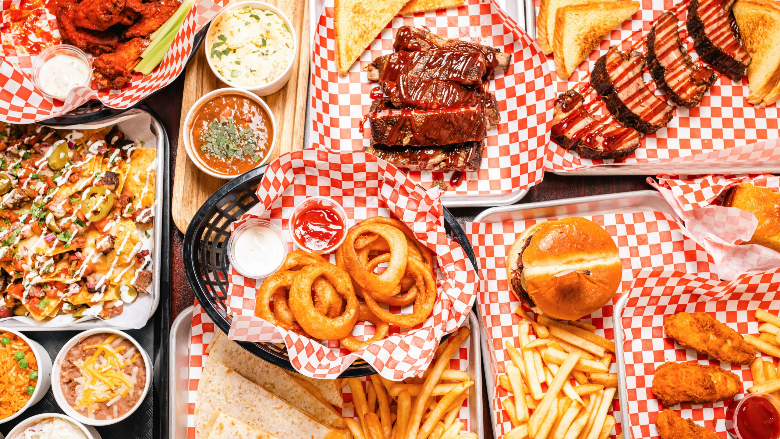 Assorted American barbecue platter with ribs, wings, and nachos