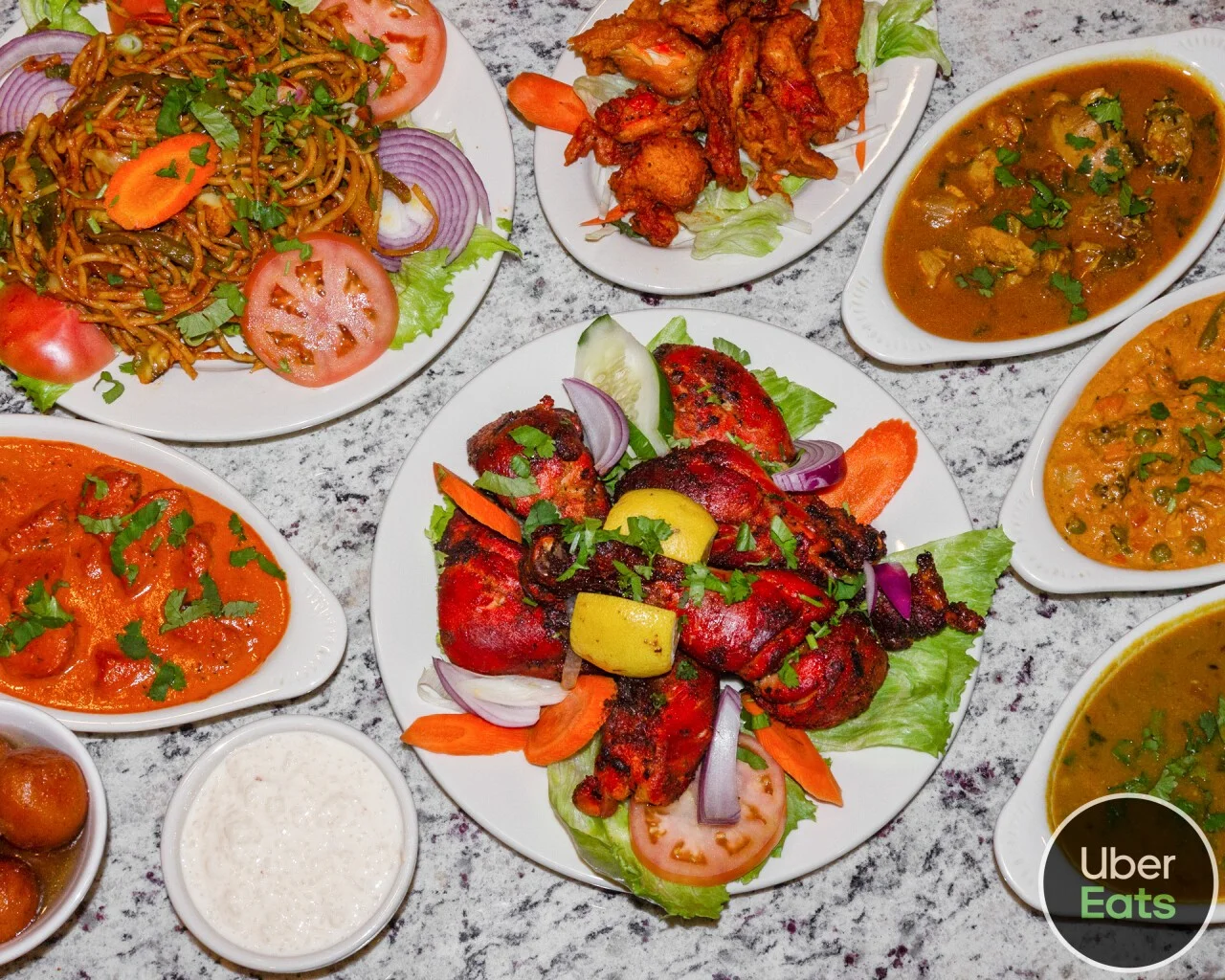 Assorted Indian dishes including tandoori chicken and curries