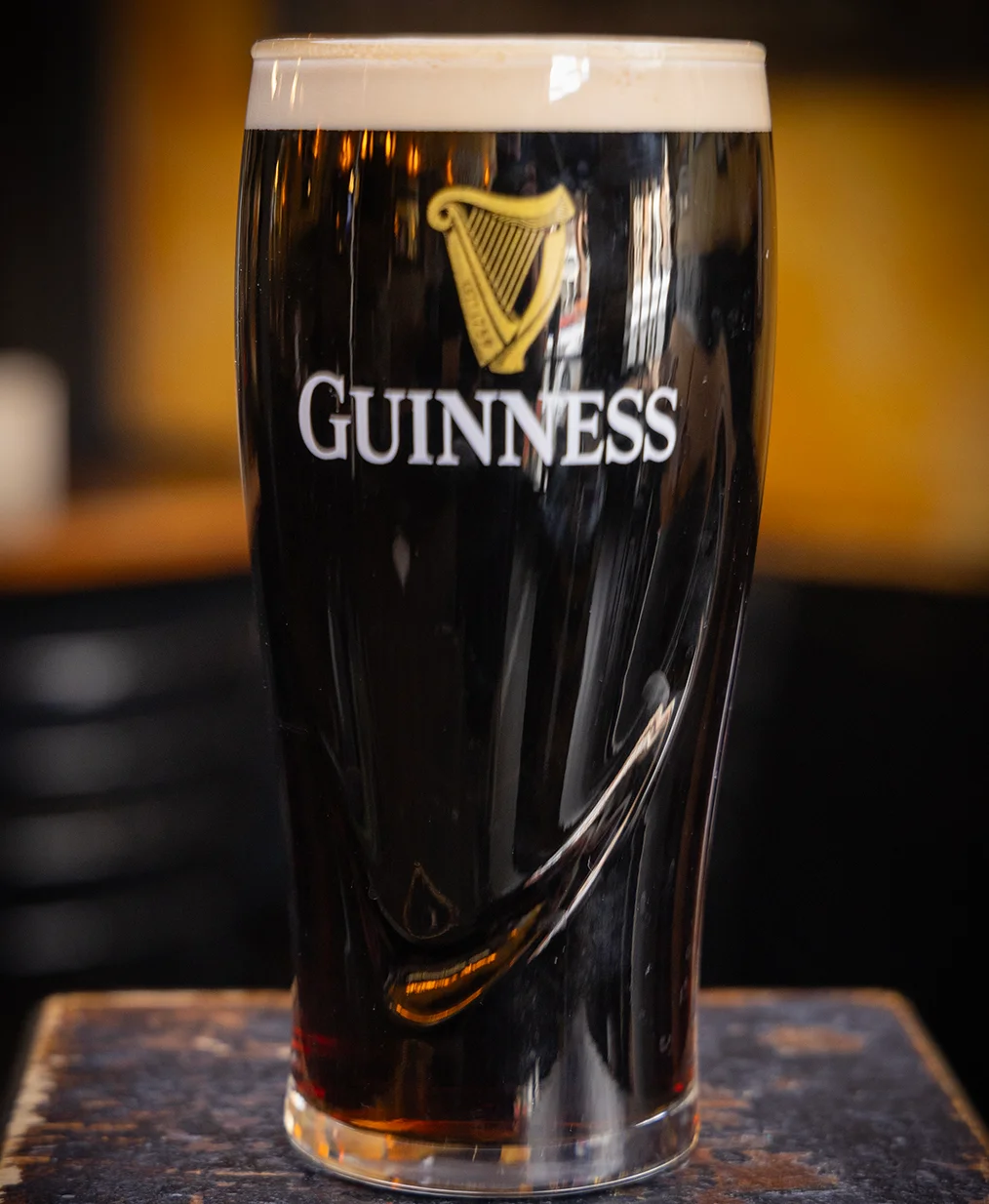 Pint of Guinness stout on a bar counter