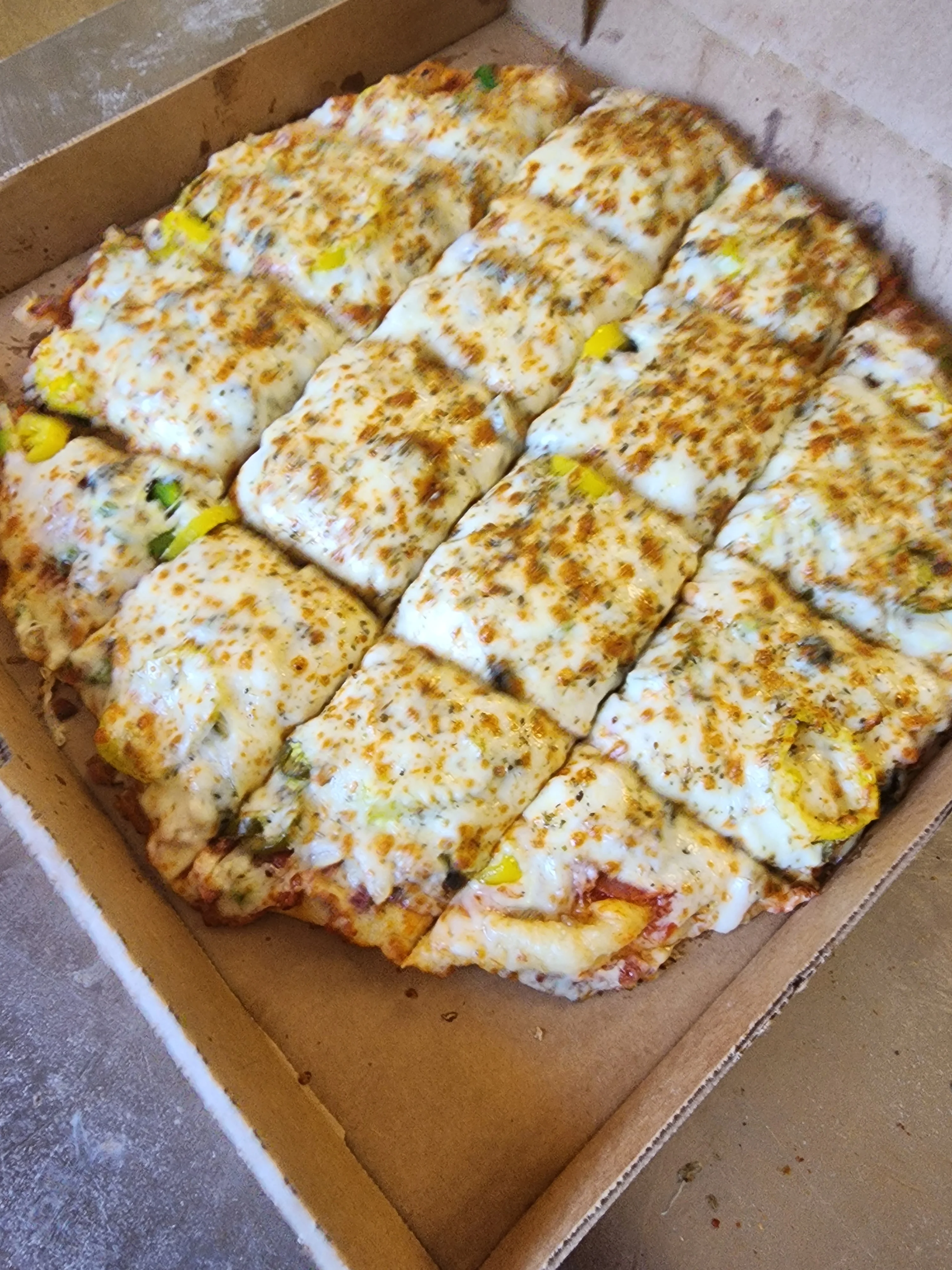Cheesy vegetarian pizza in a pizza box