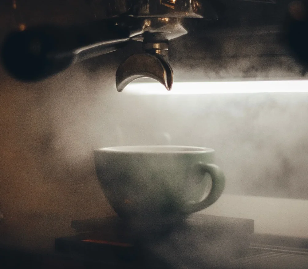 espresso maker pouring coffee in a mug