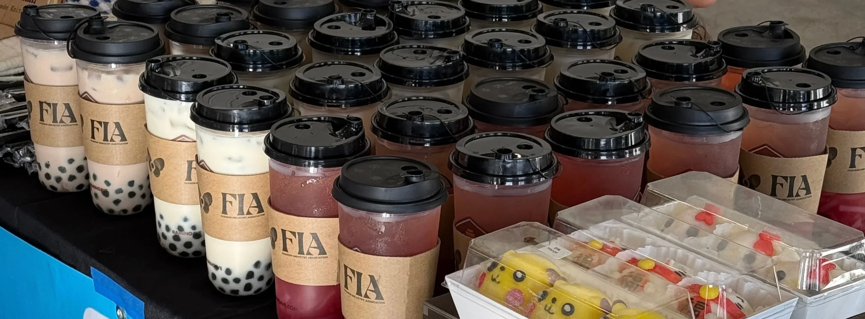 Assorted bubble tea drinks on display at a market