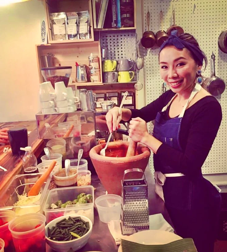 Preparing Thai papaya salad in a rustic kitchen