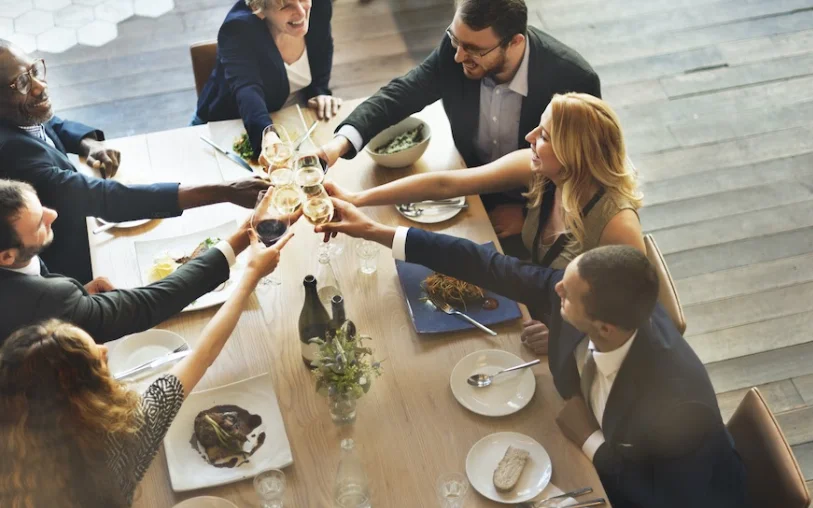 Group toasting with glasses at a festive dining table