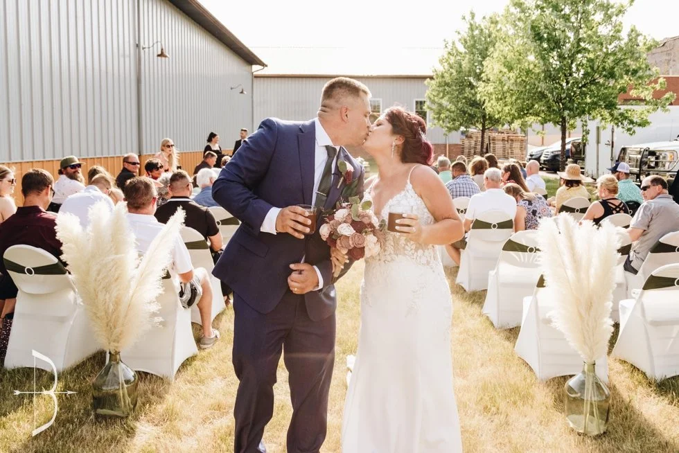A couple kissing after their wedding ceremony