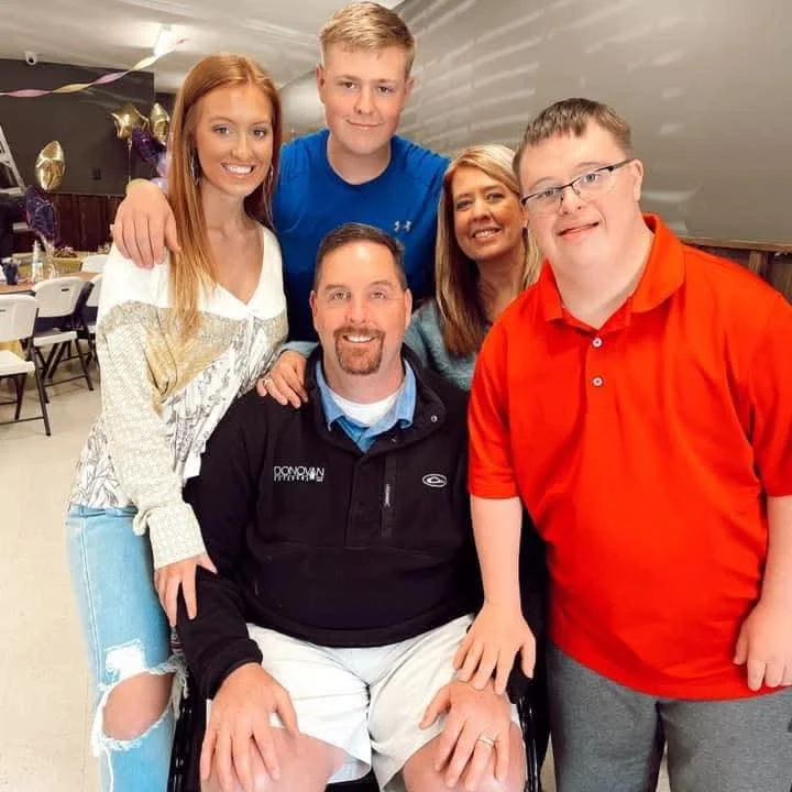 Family portrait with five members smiling together