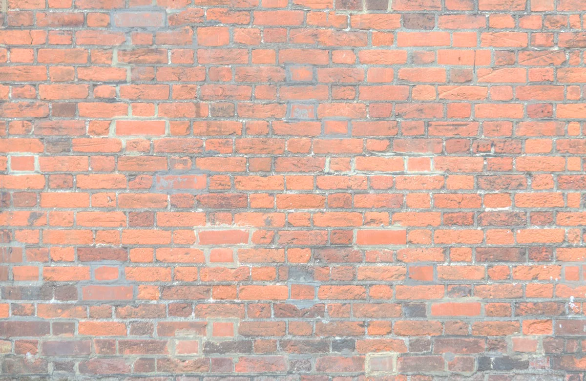 Exposed brick wall texture in a rustic setting