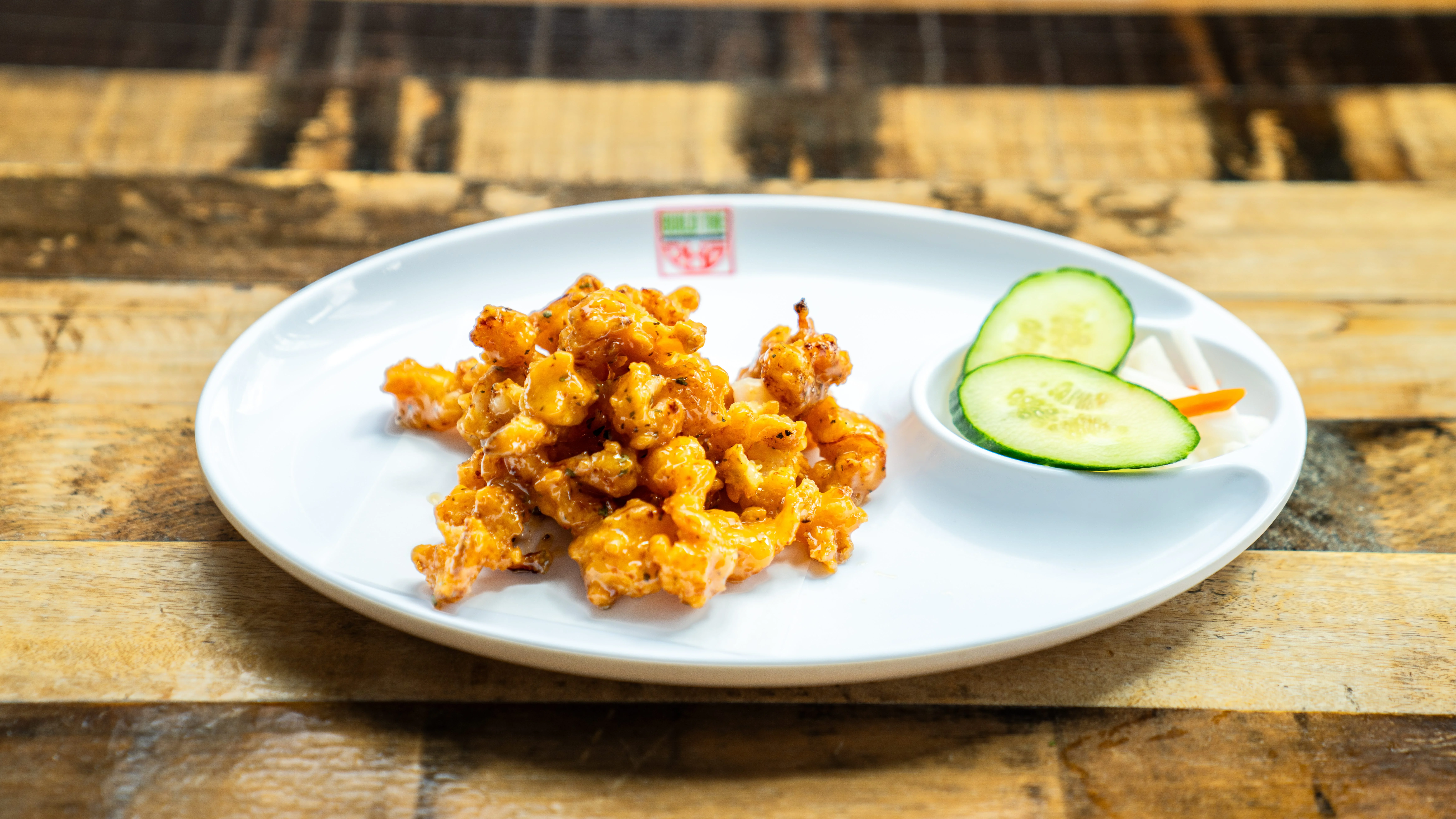 Crispy Chinese orange chicken with cucumber slices