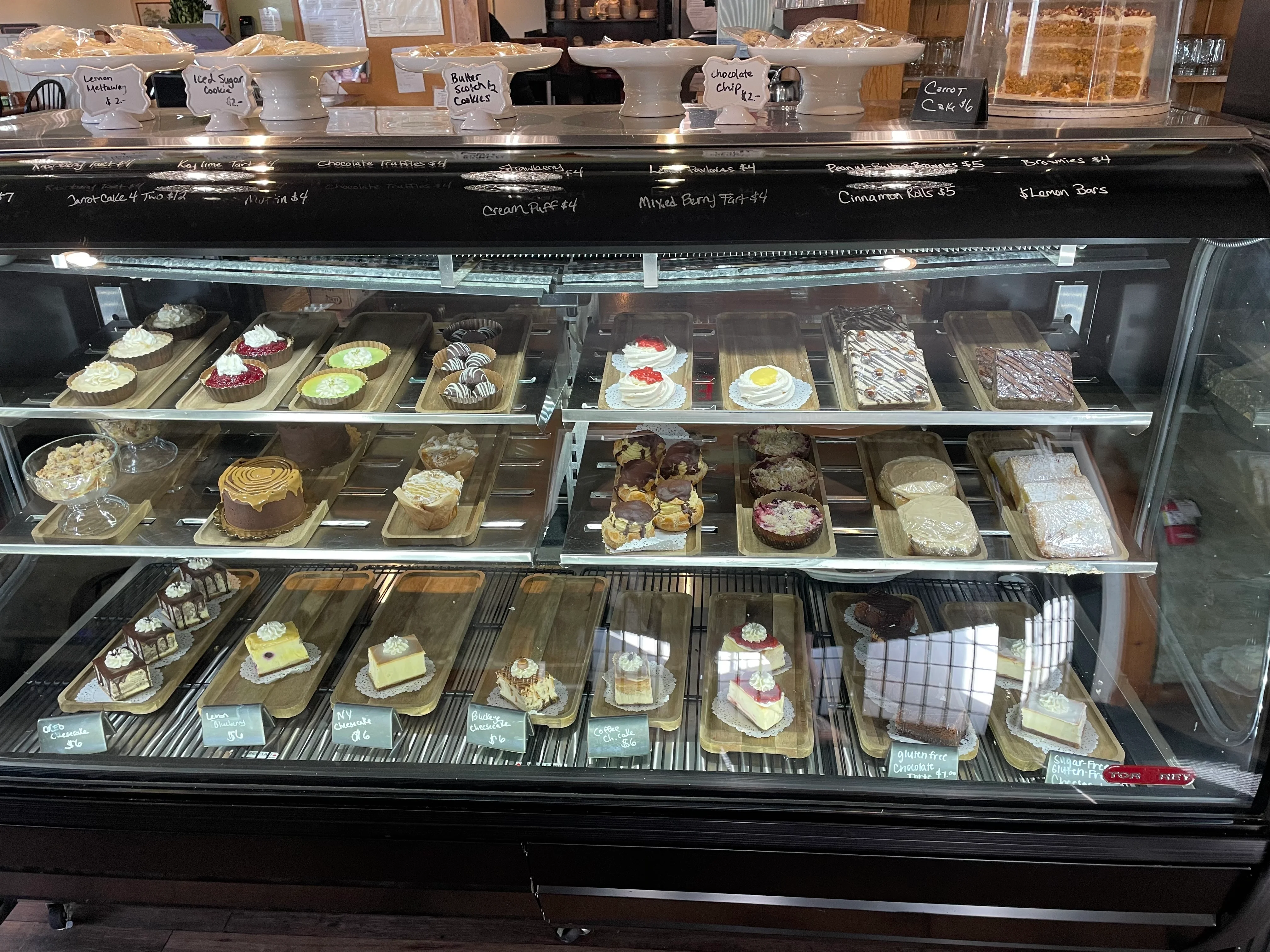 Assorted desserts in a bakery display case