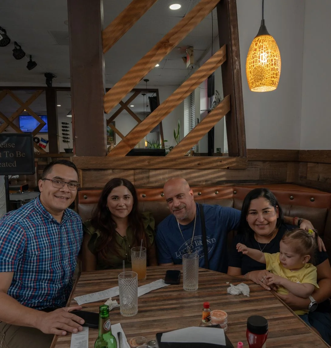 Group of friends enjoying drinks at a restaurant table.
