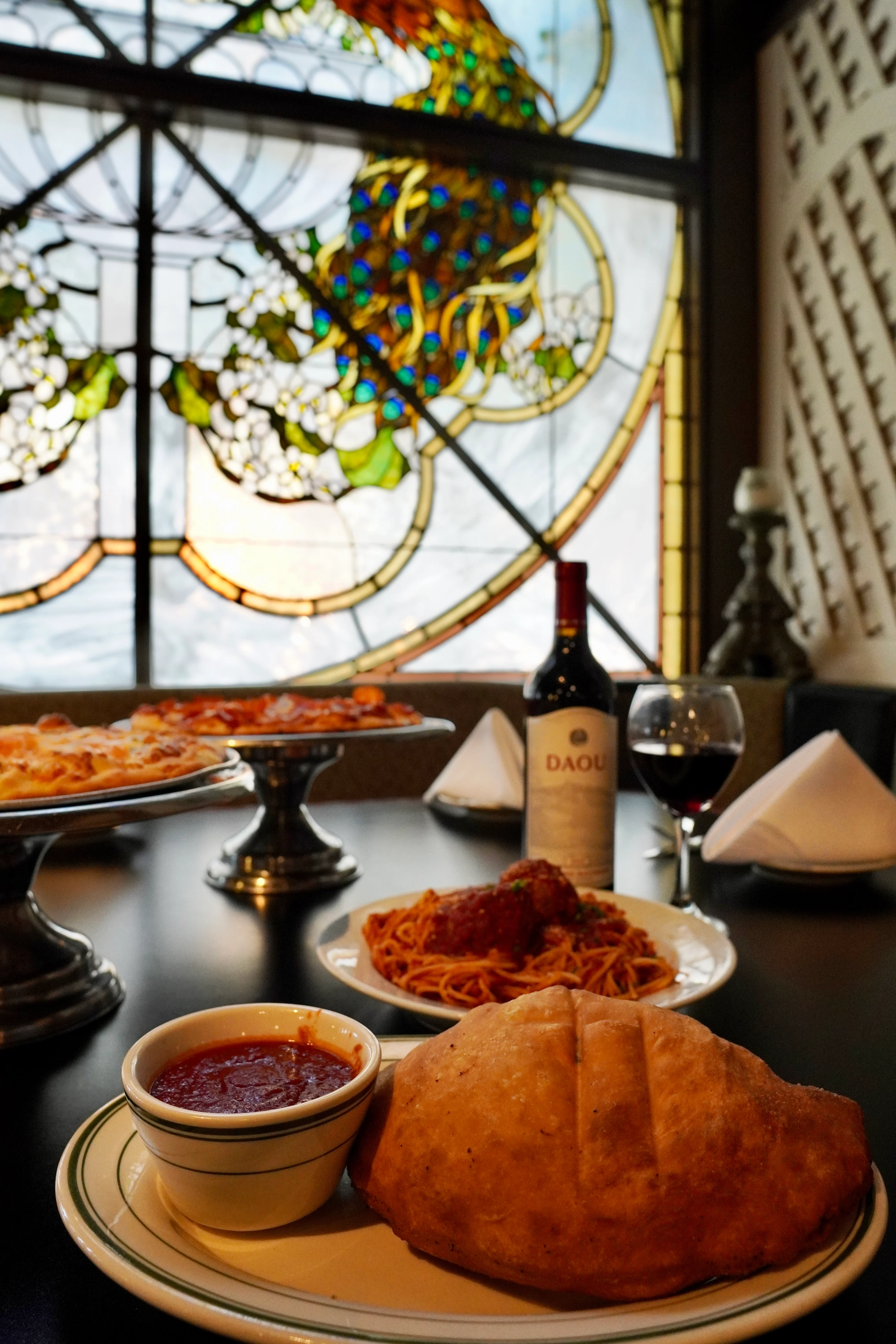 Italian calzone with marinara sauce and spaghetti in a cozy restaurant setting