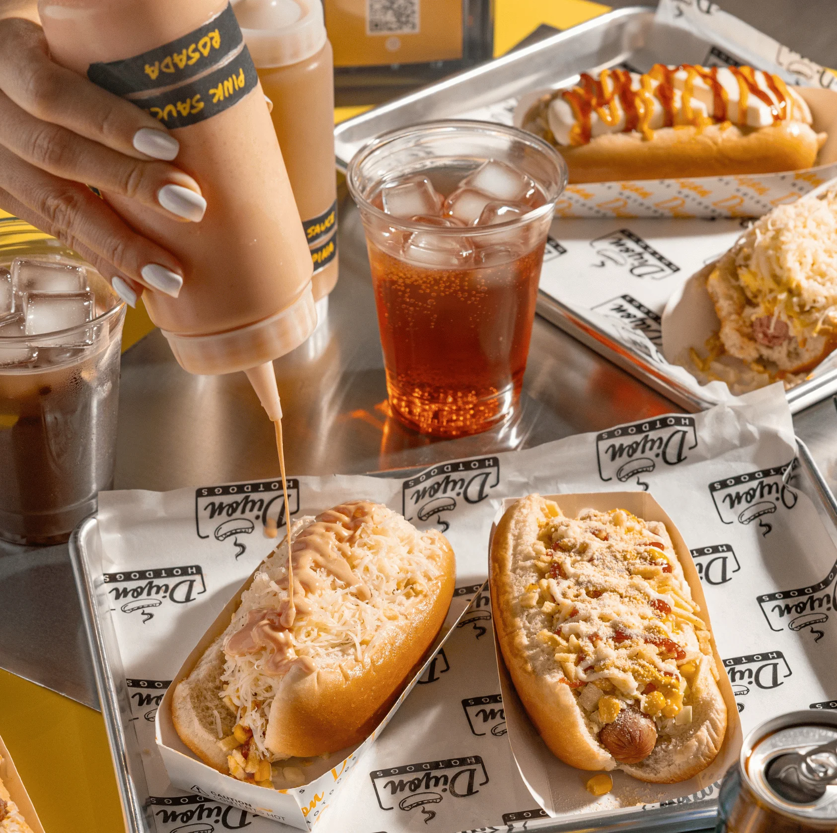 Variety of gourmet hot dogs served with sauces
