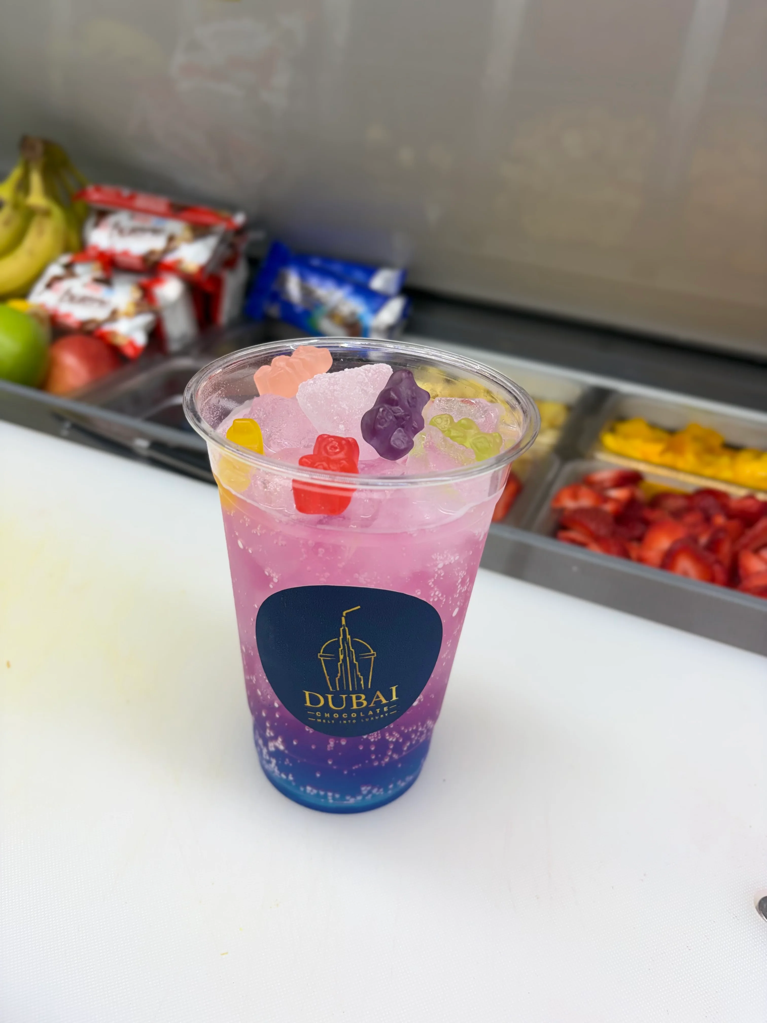 Colorful drink with gummy bears in a clear cup
