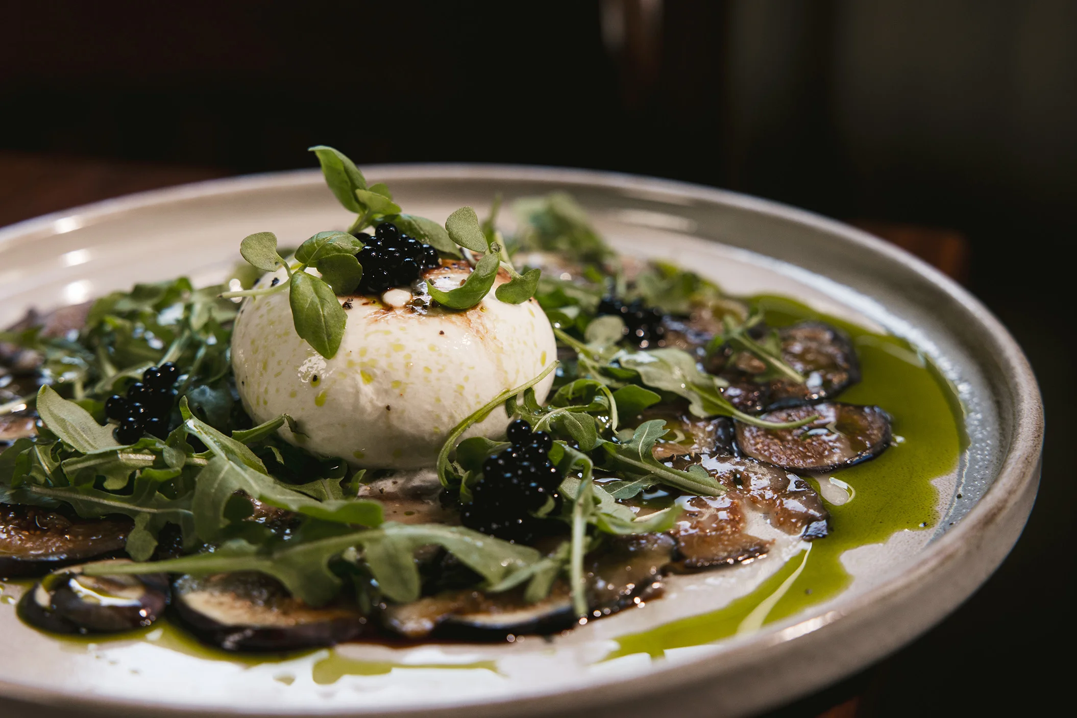 Italian burrata salad with arugula and caviar