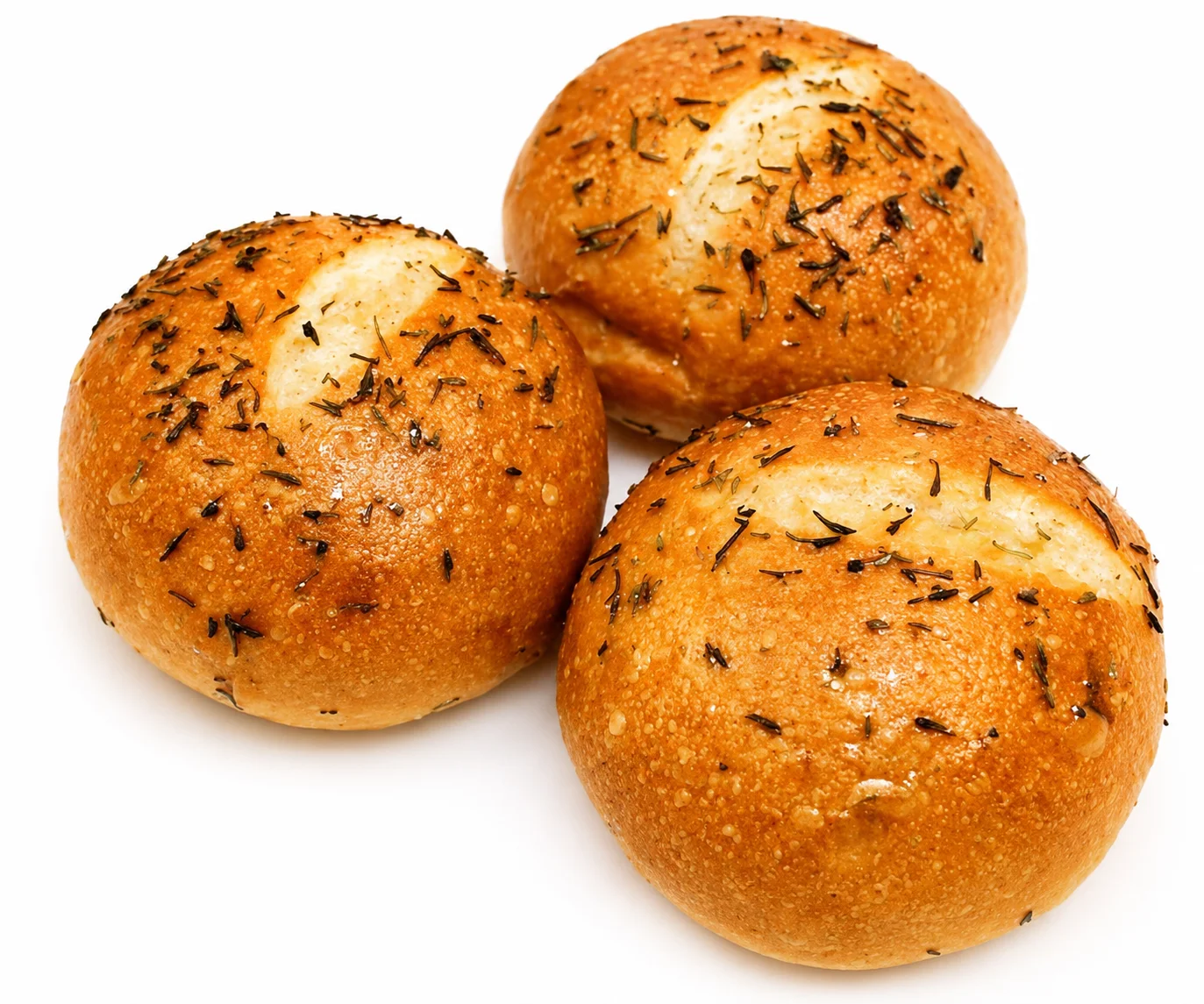 Three freshly baked round bread rolls topped with herbs.
