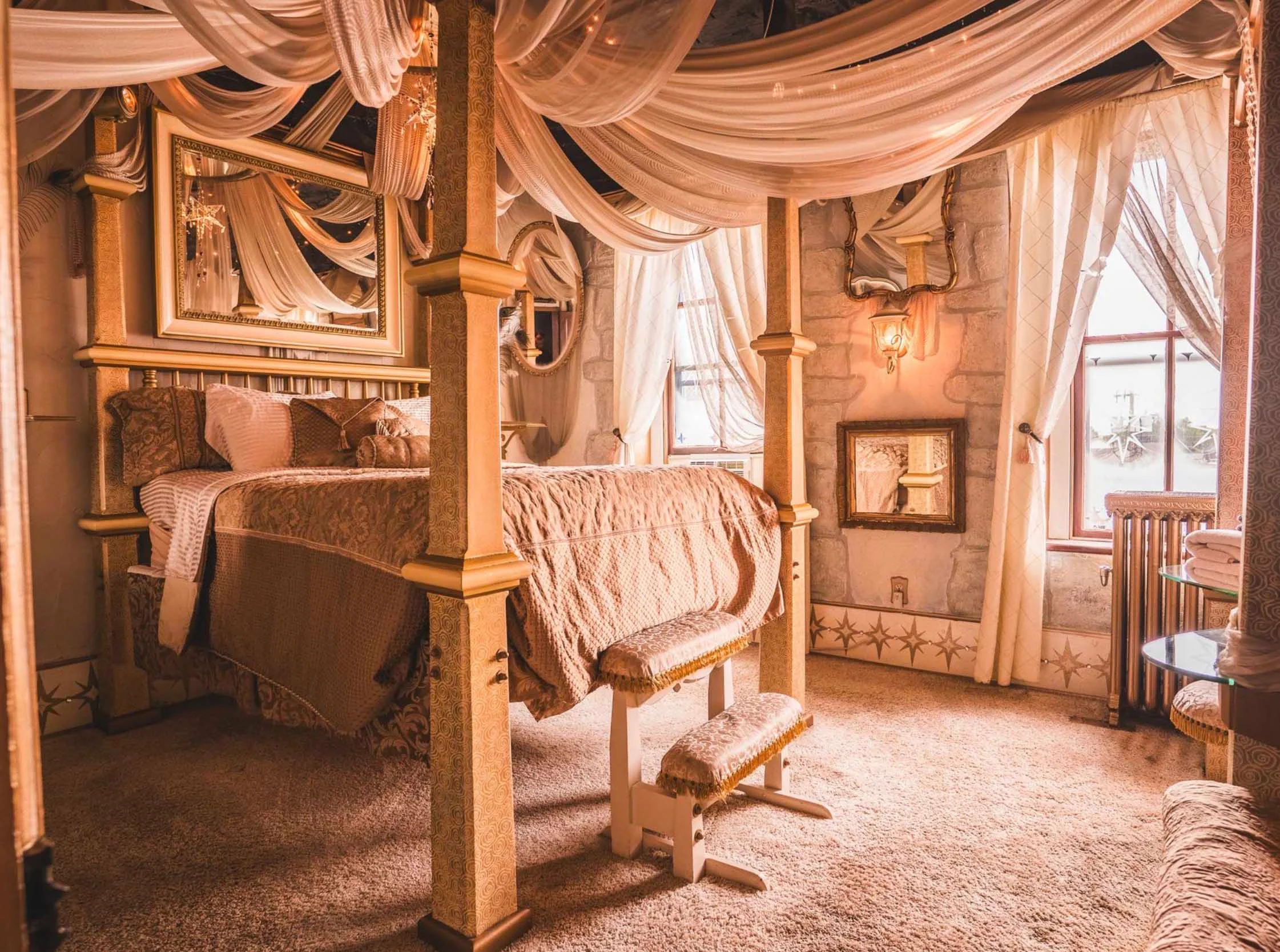 Elegant bedroom with a four-poster bed and soft drapery.