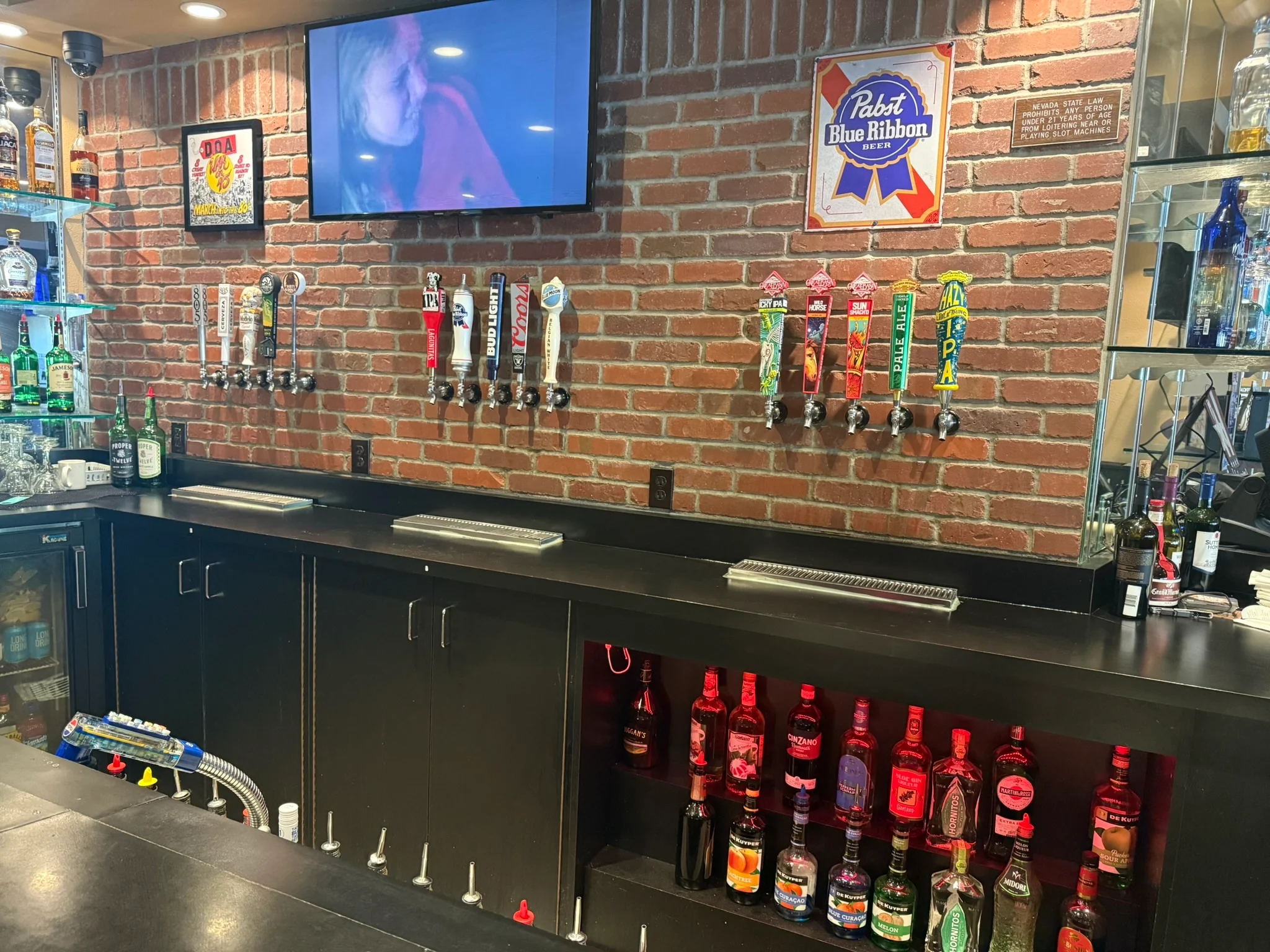 Modern bar counter with craft beer taps and liquor display