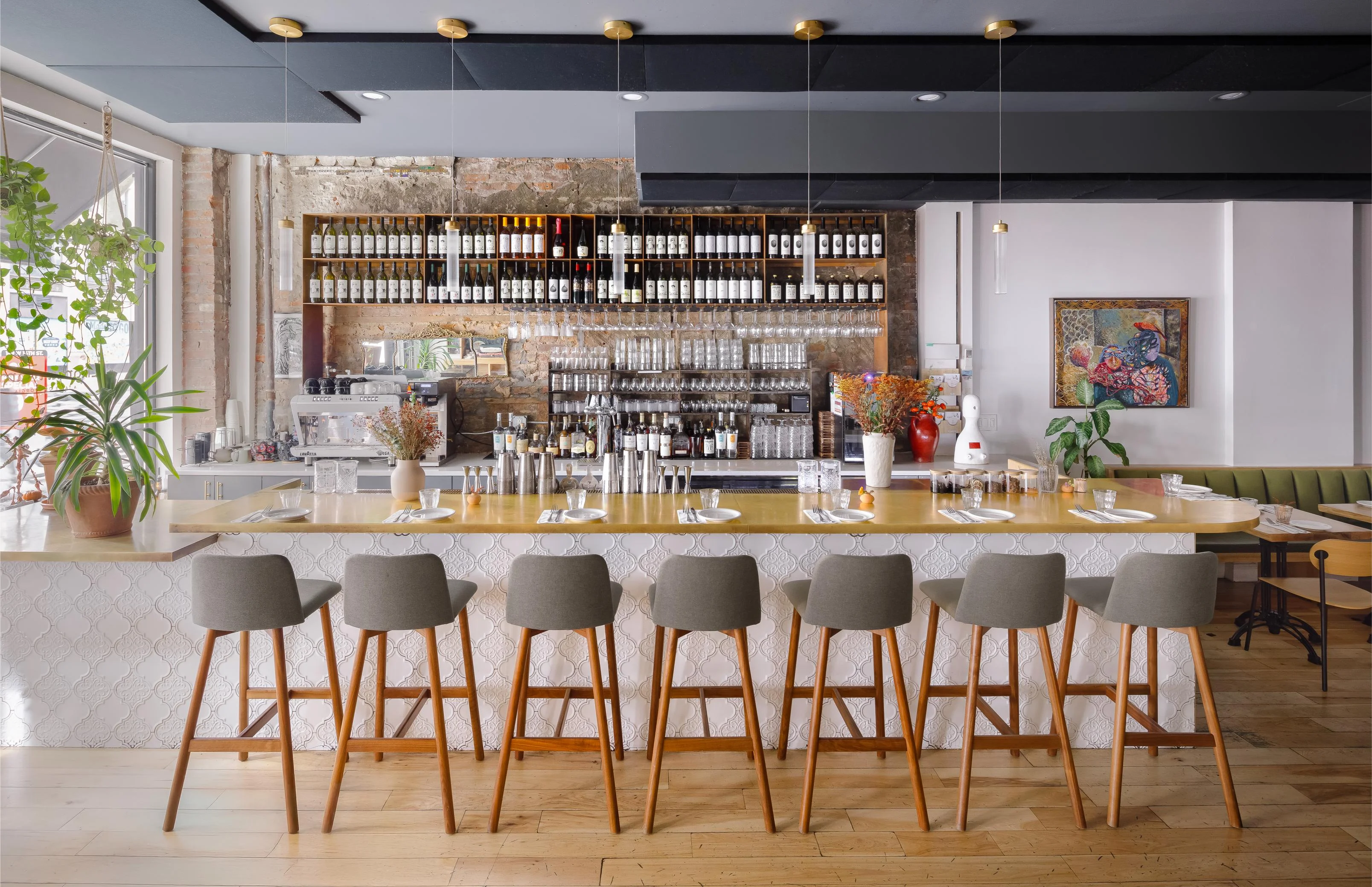 Modern bar interior with stylish seating and wine display