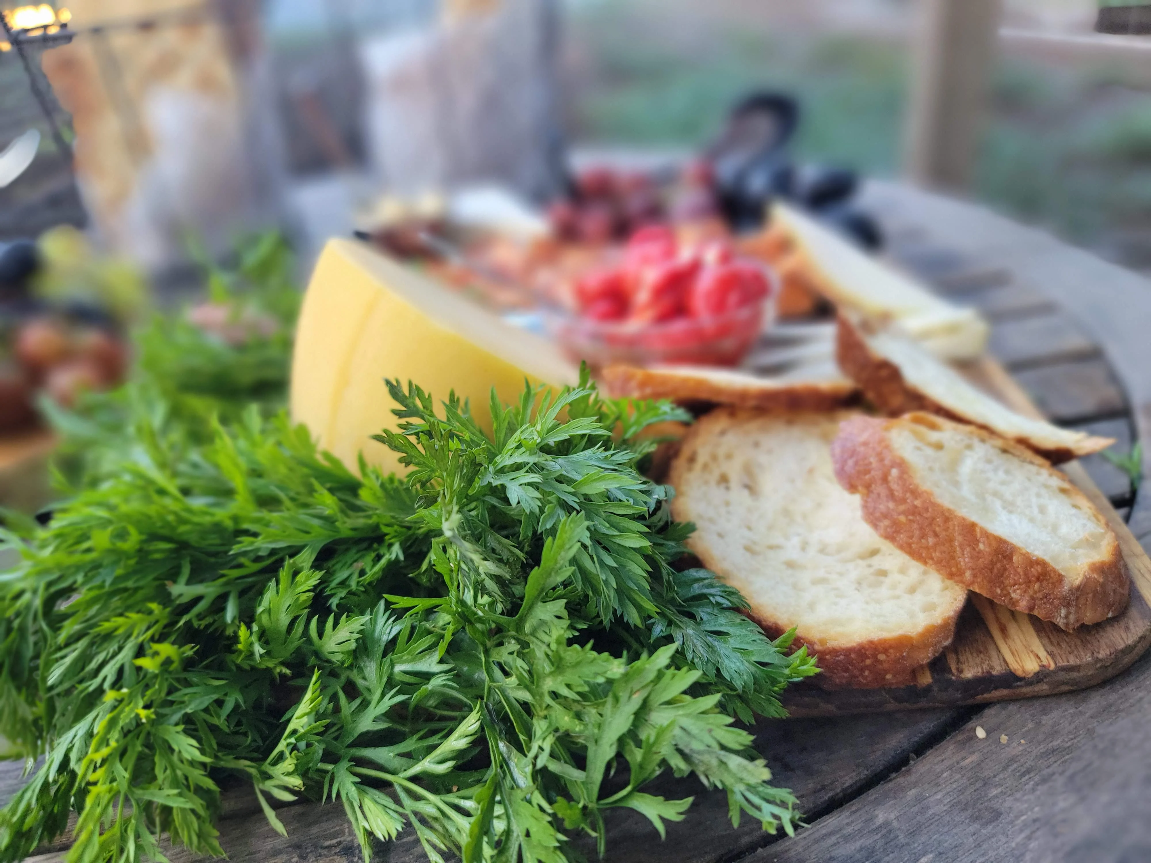 Artisan cheese platter with fresh bread and herbs