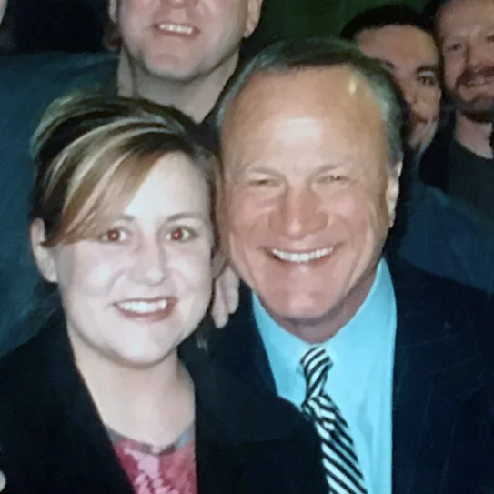 Two people smiling together at an event