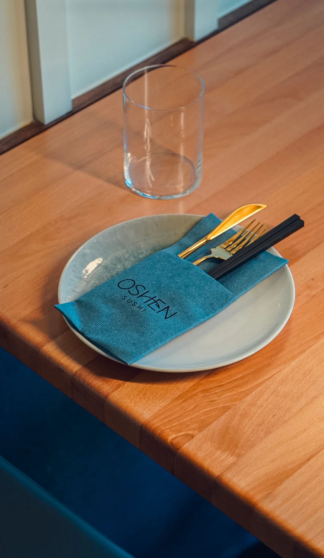 Elegant sushi dining setup with gold utensils