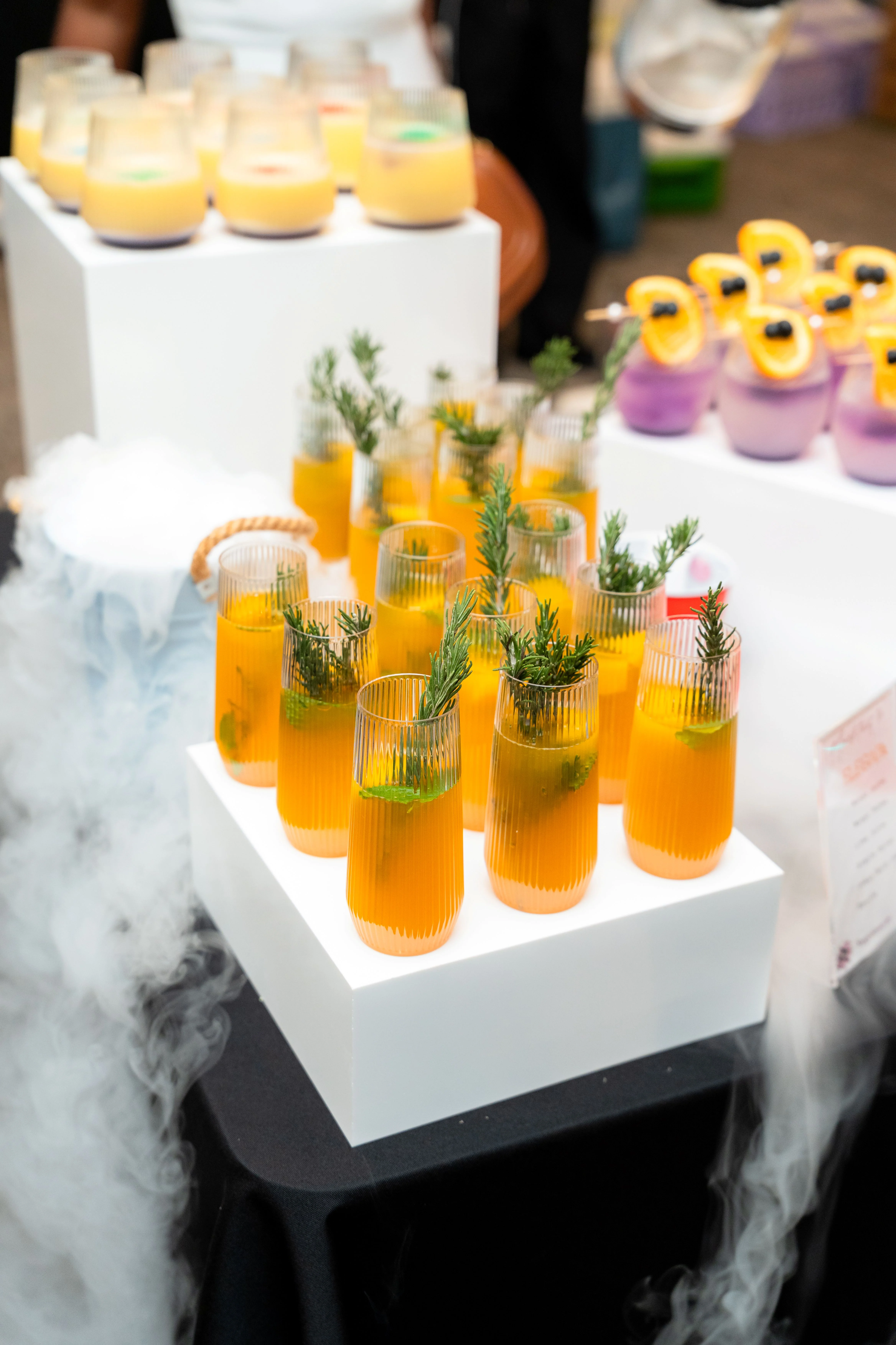 Colorful cocktails with herbs at a vibrant event