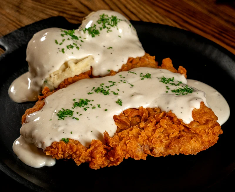 Southern fried chicken with creamy gravy and mashed potatoes