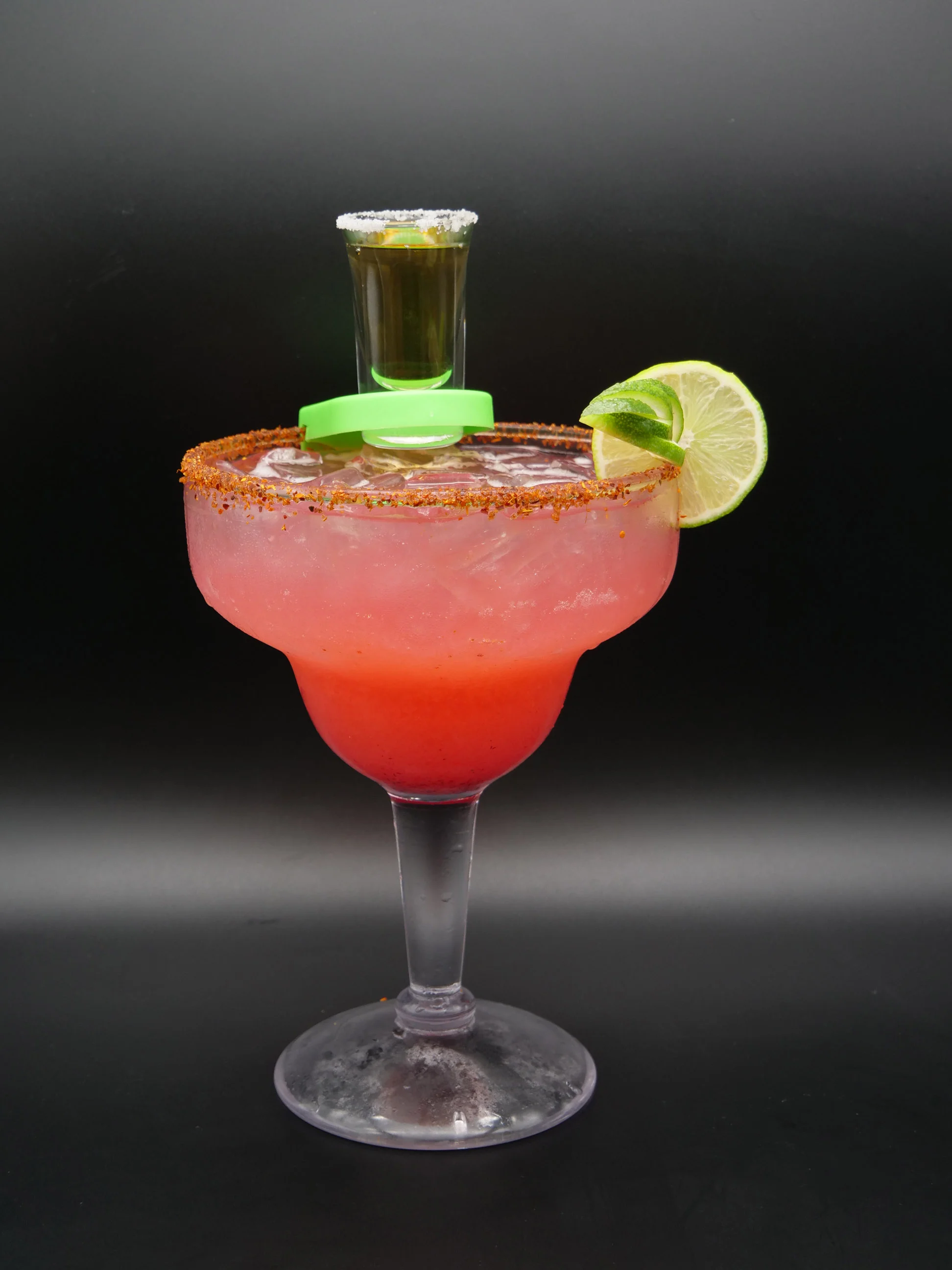 Colorful margarita cocktail with a shot on top