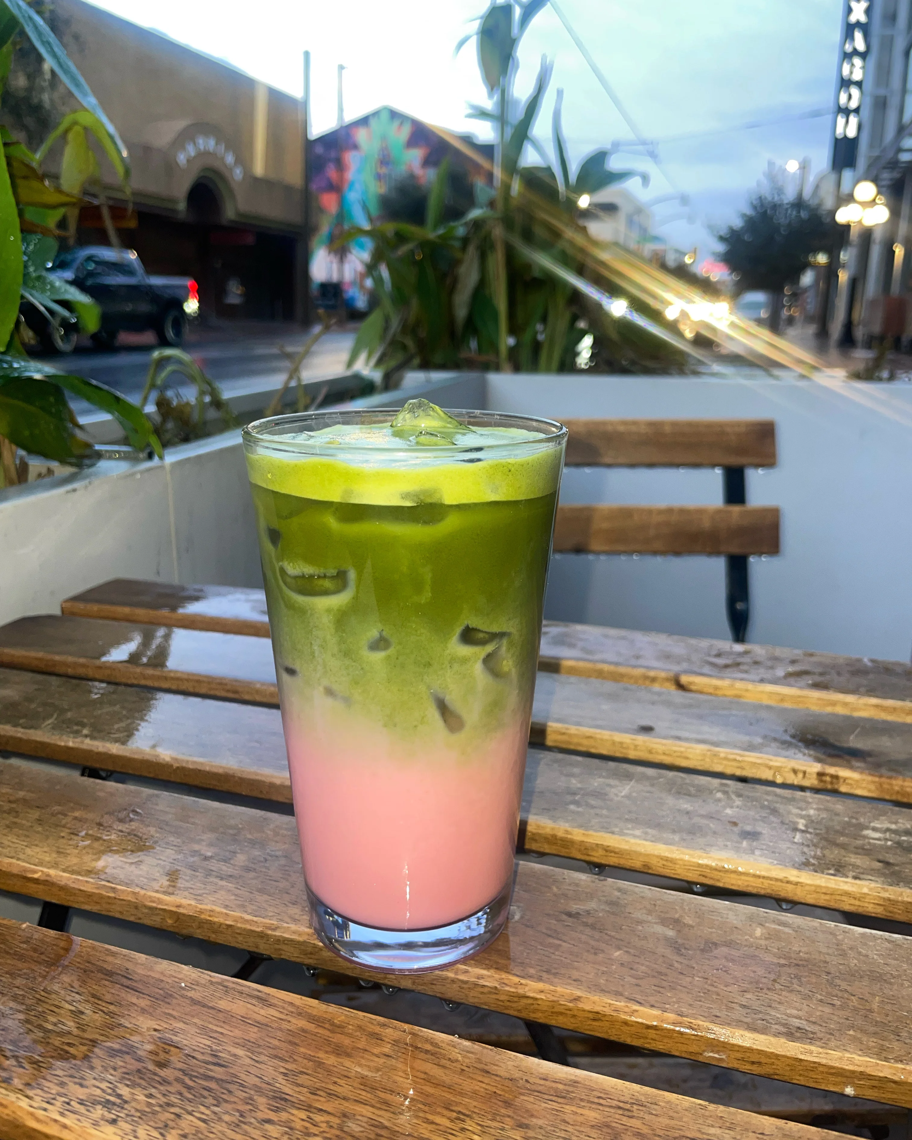 Layered matcha and strawberry drink in a glass