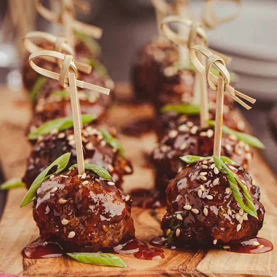 Asian-style meatballs with sweet sauce and sesame seeds