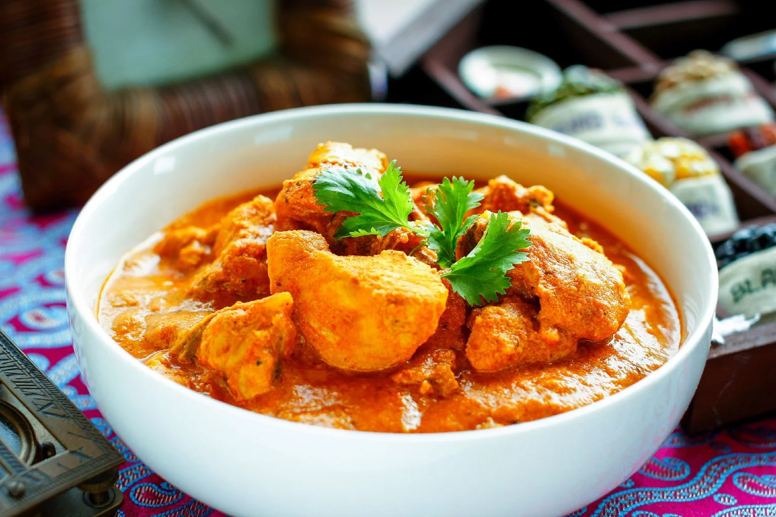 Delicious butter masala dish served in a bowl with garnishes.