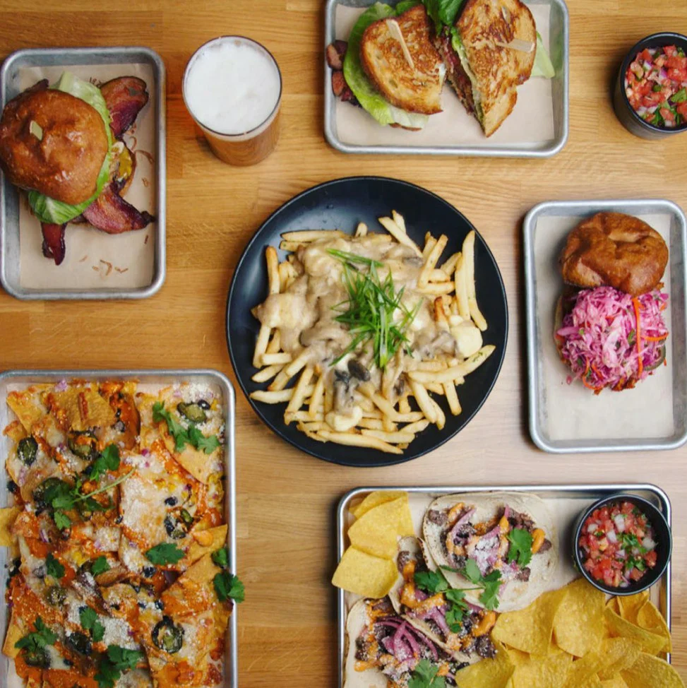 Loaded nachos and gourmet burgers in a vibrant restaurant setting