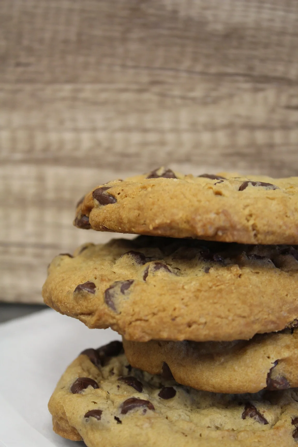 Freshly baked chocolate chip cookies stacked